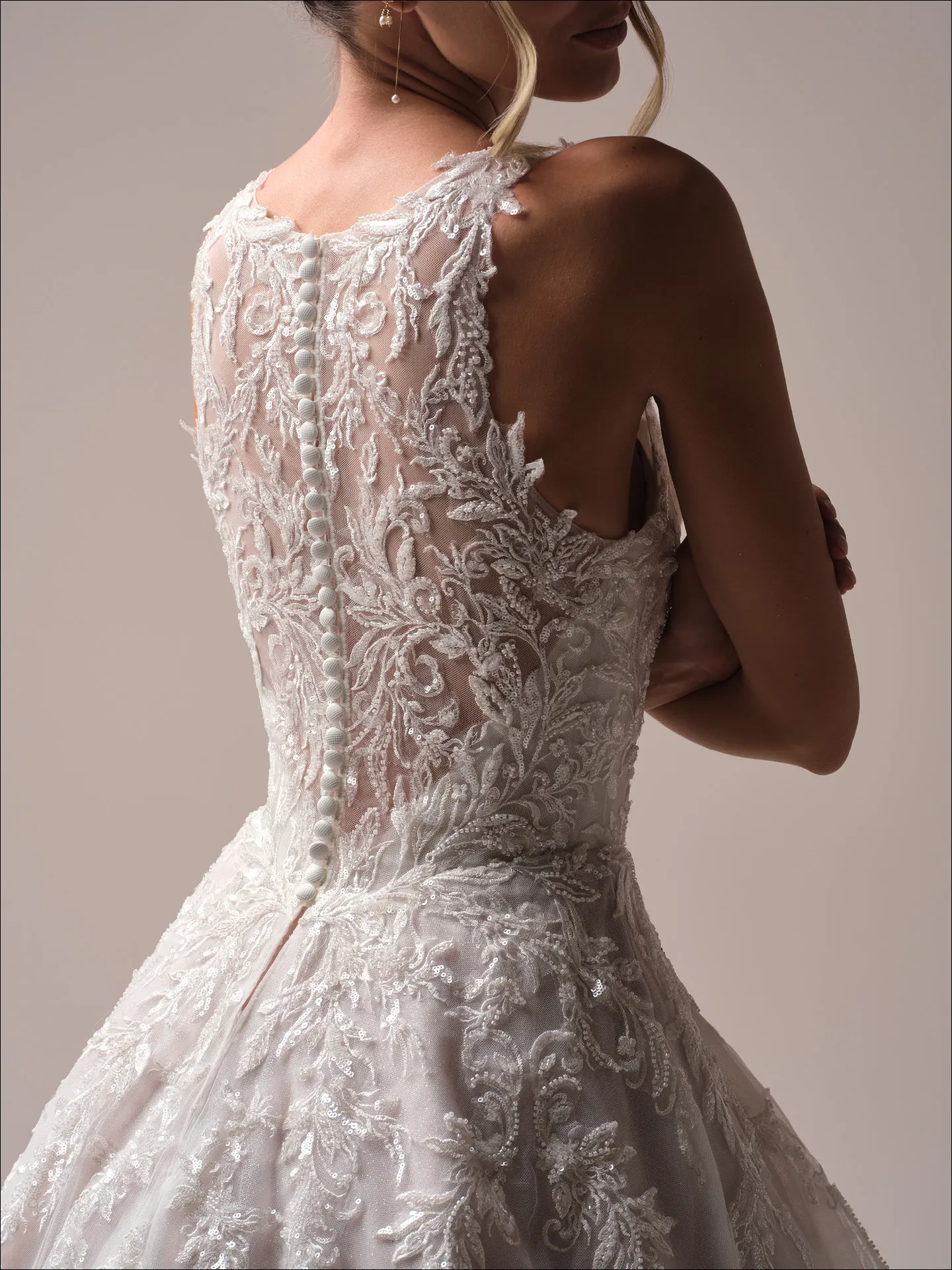Maggie Sottero Nina A line wedding dress side angle with lace bodice detail