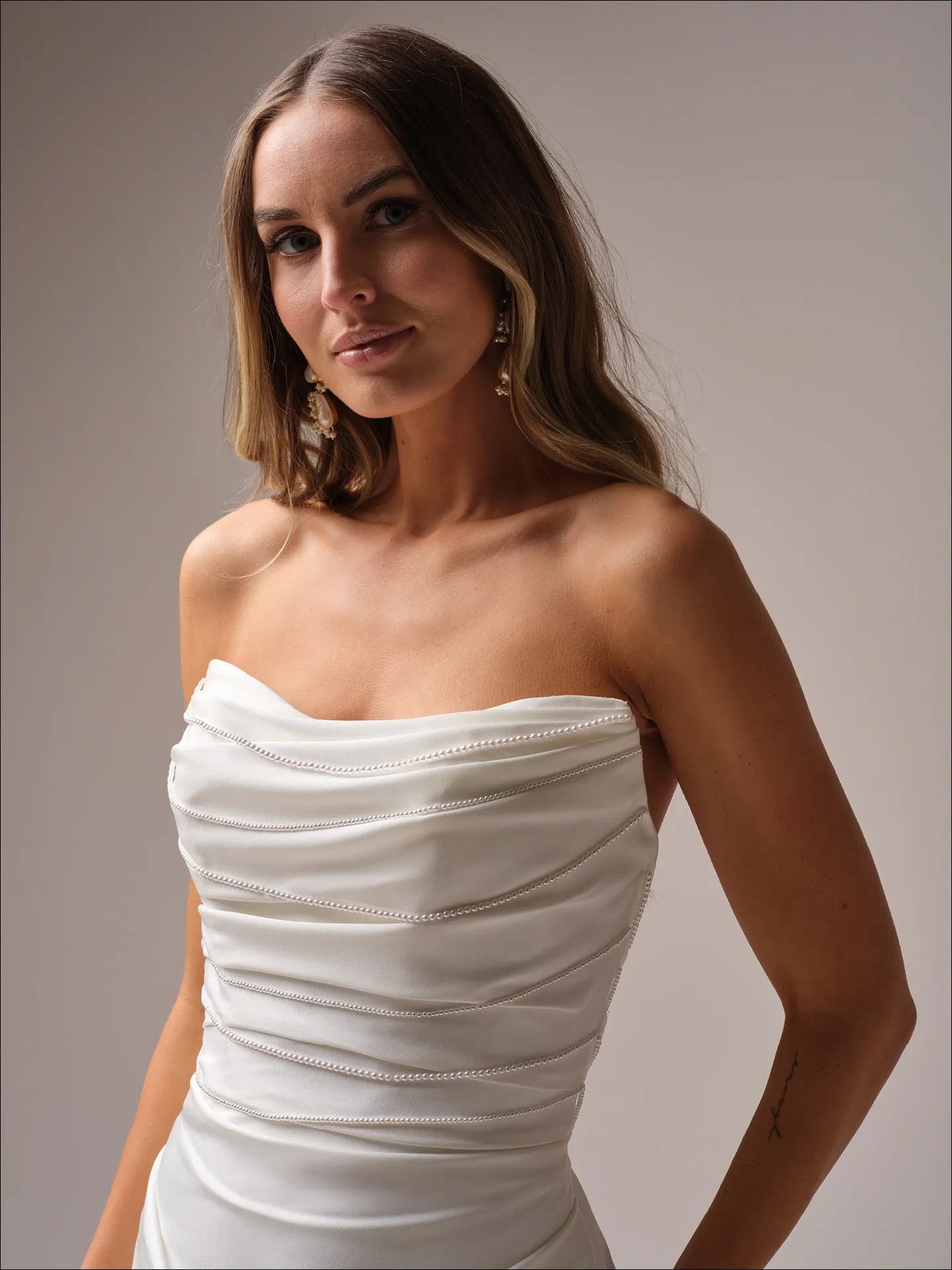 Maggie Sottero Rhoda sheath wedding dress side view with sleek fitted skirt
