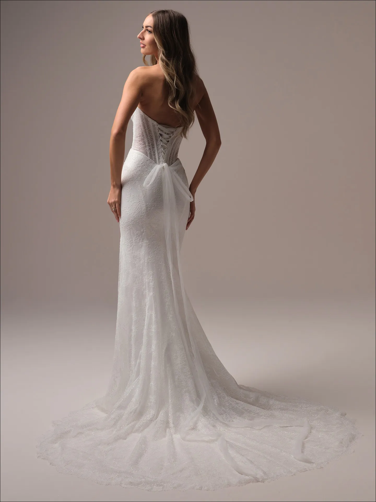 Maggie Sottero Sasha sheath wedding dress back angle with extended train