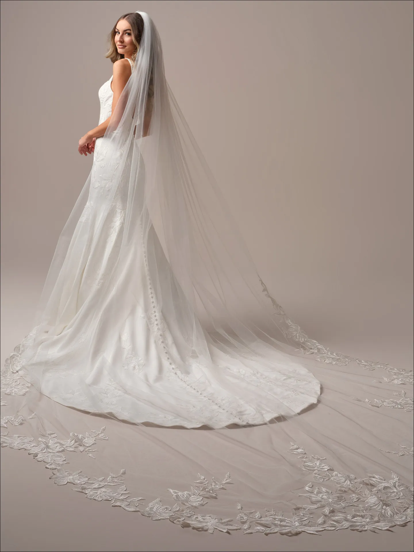 Maggie Sottero Sheridan Lane fit and flare wedding dress back angle with flowing train