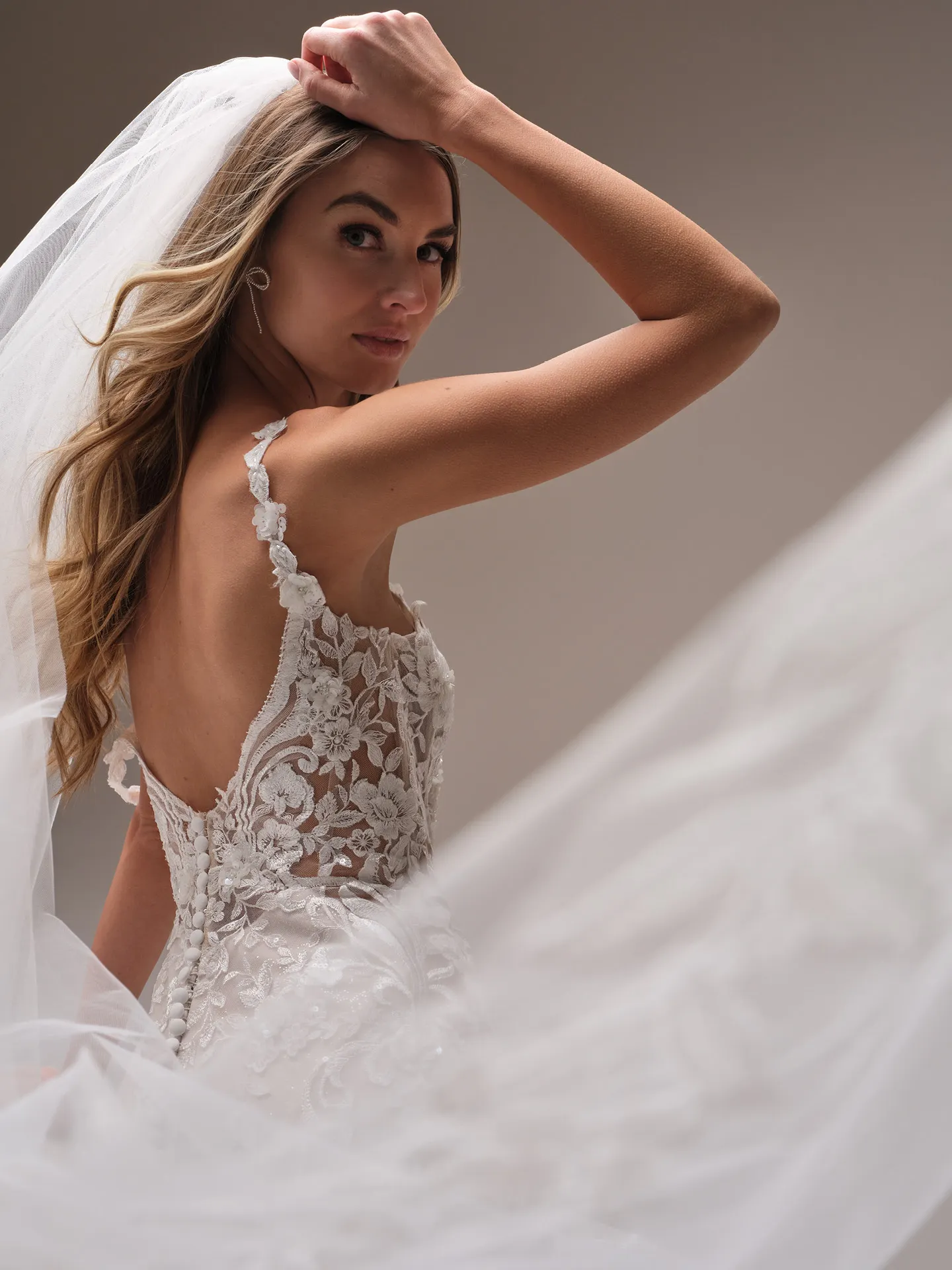 Maggie Sottero Sonoma fit and flare wedding dress back angle with flowing train