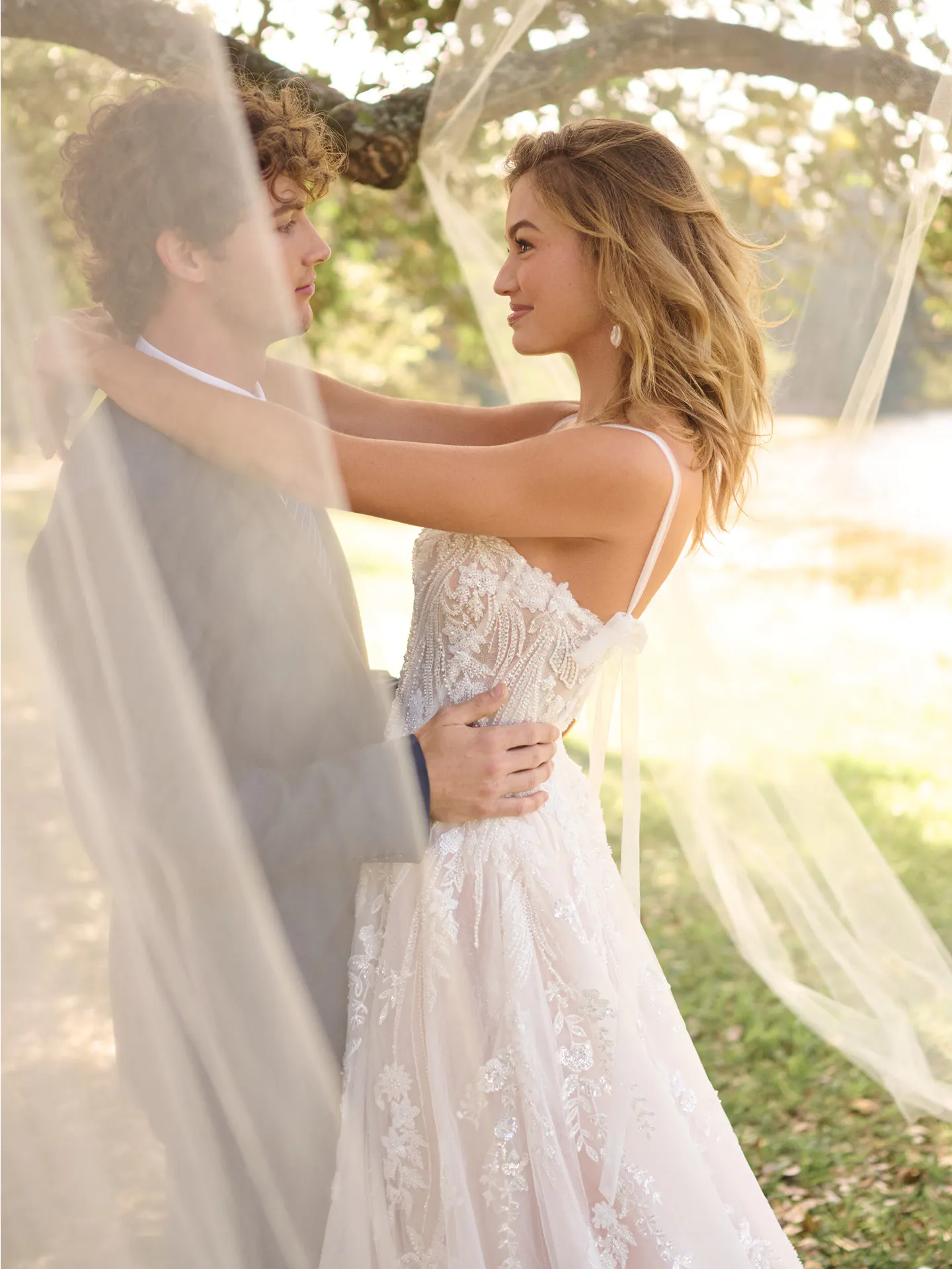 Rebecca Ingram Angie A-line gown outdoor embrace.