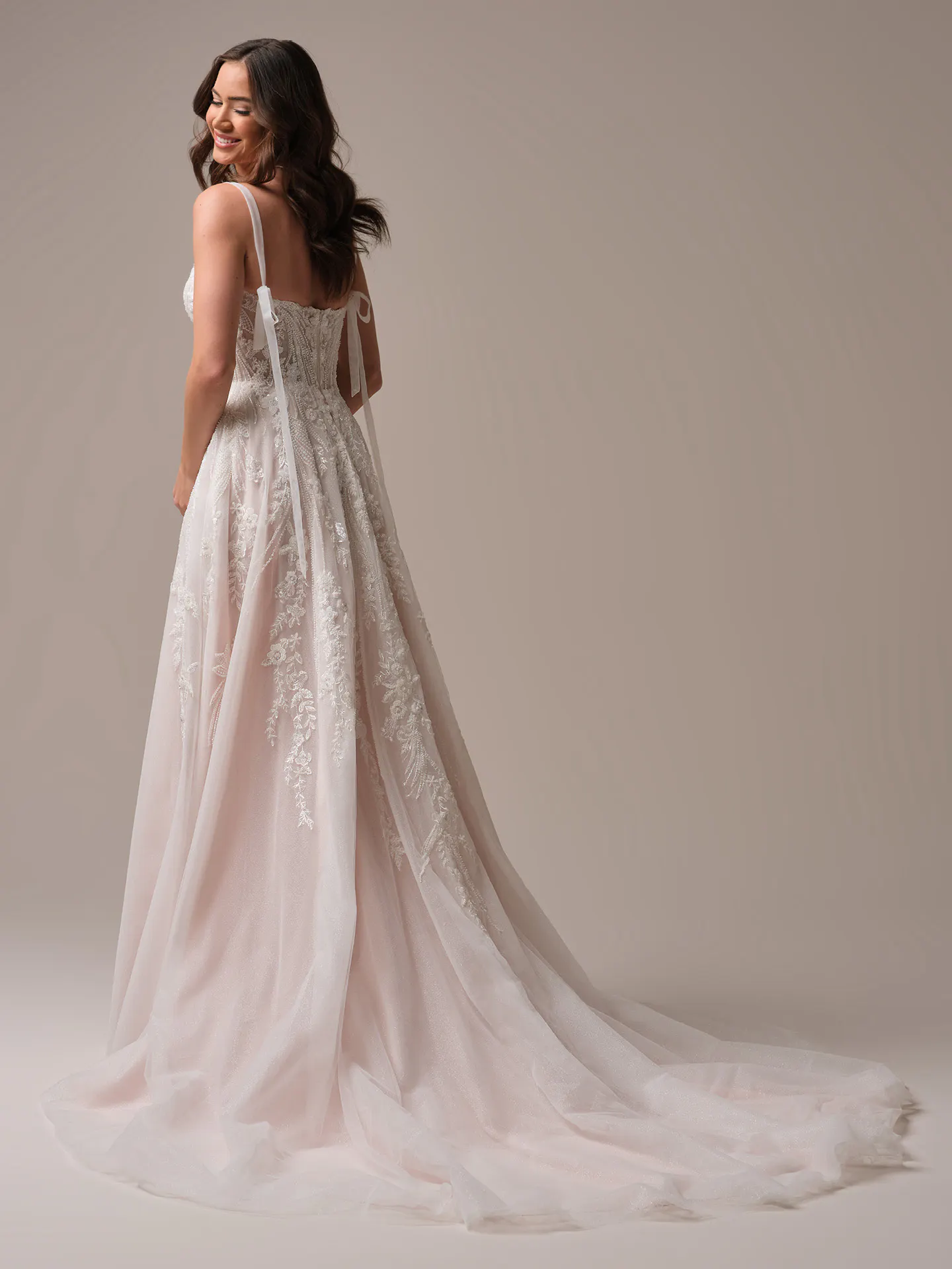 Rebecca Ingram Angie back view embroidered A-line wedding gown with long train.