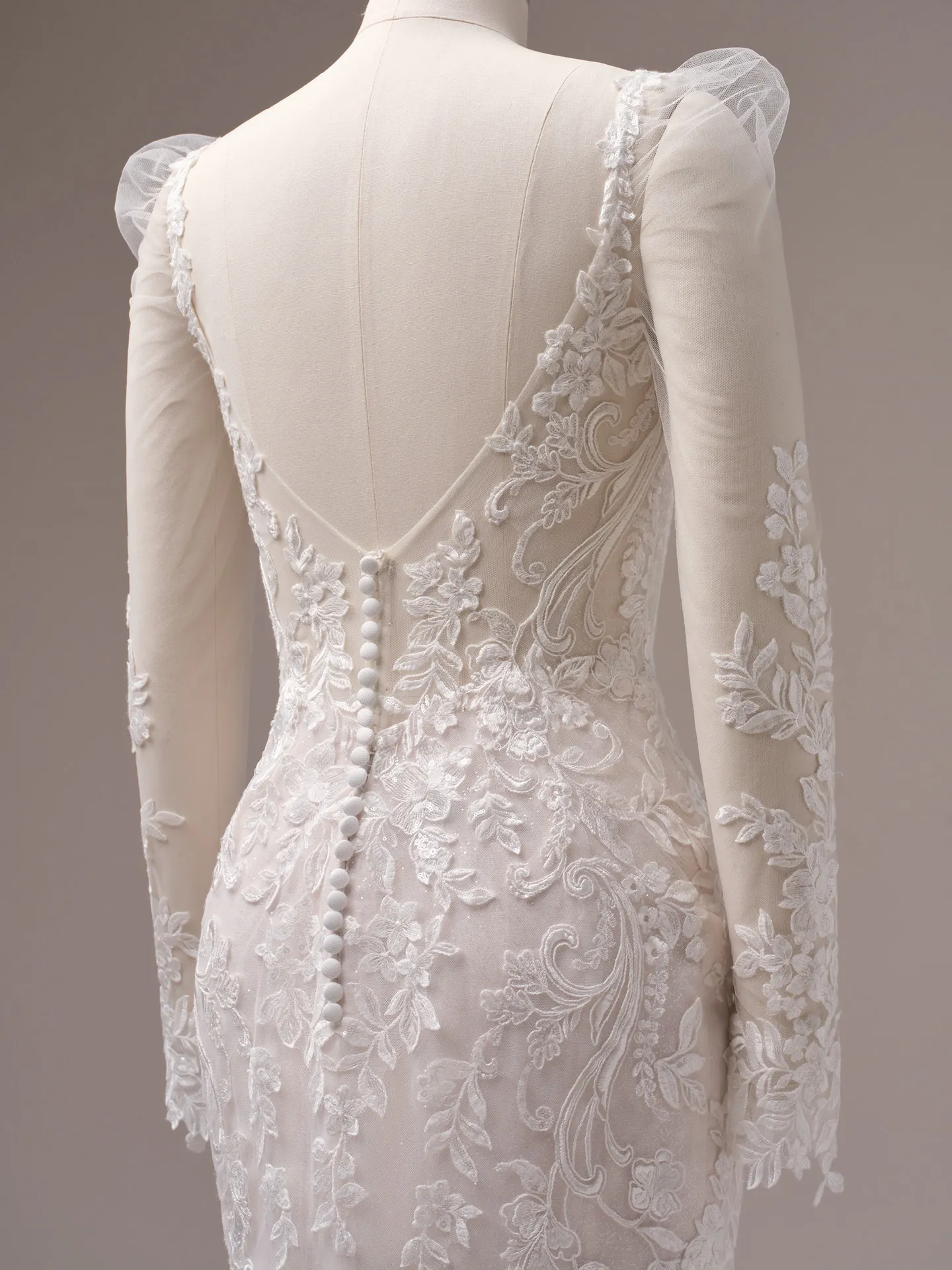 Rebecca Ingram Candice back view, sequin lace floral mermaid gown with buttons and floral patterns.