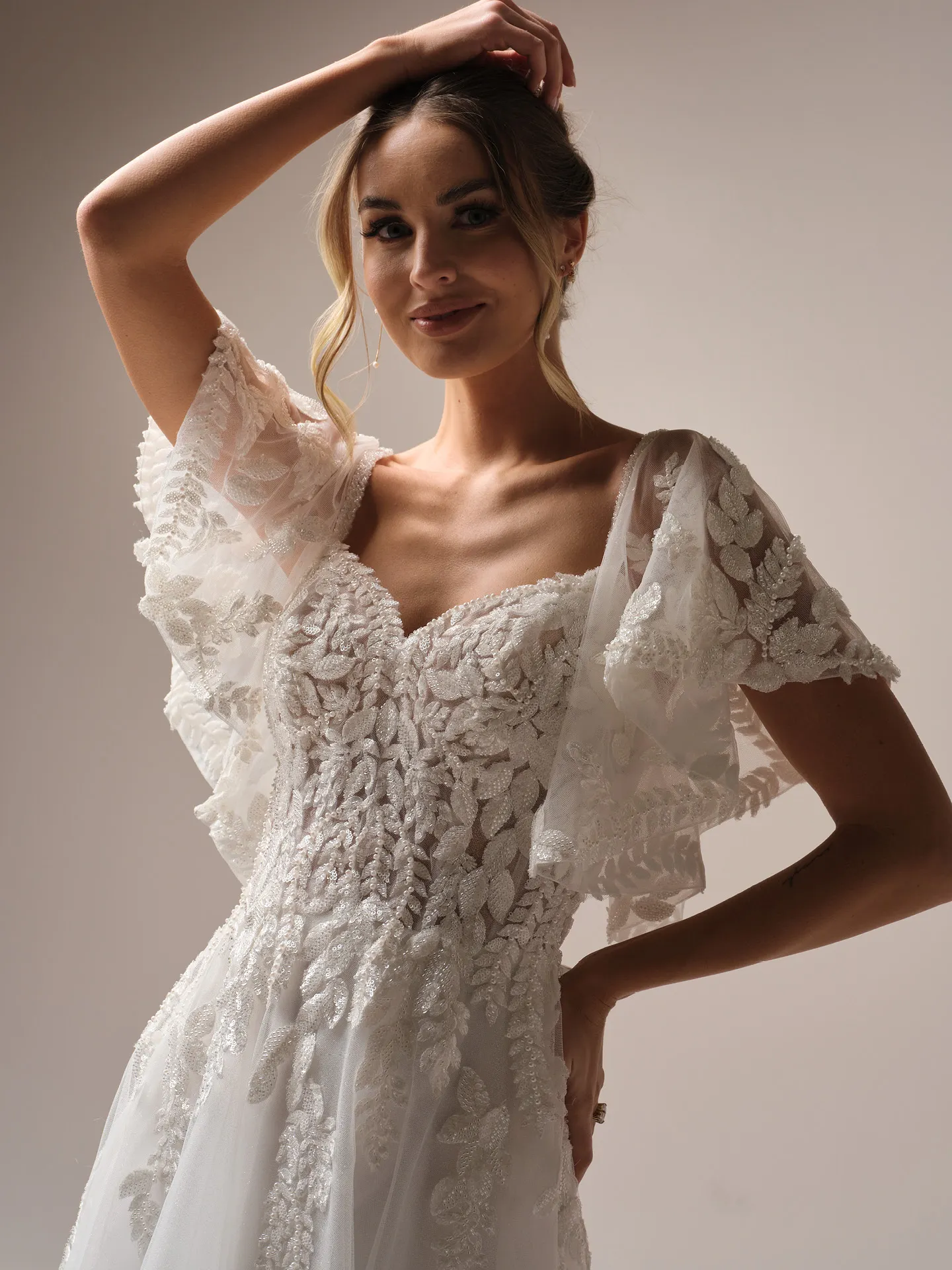 Rebecca Ingram Carmen front view with lace detail and flutter sleeves.