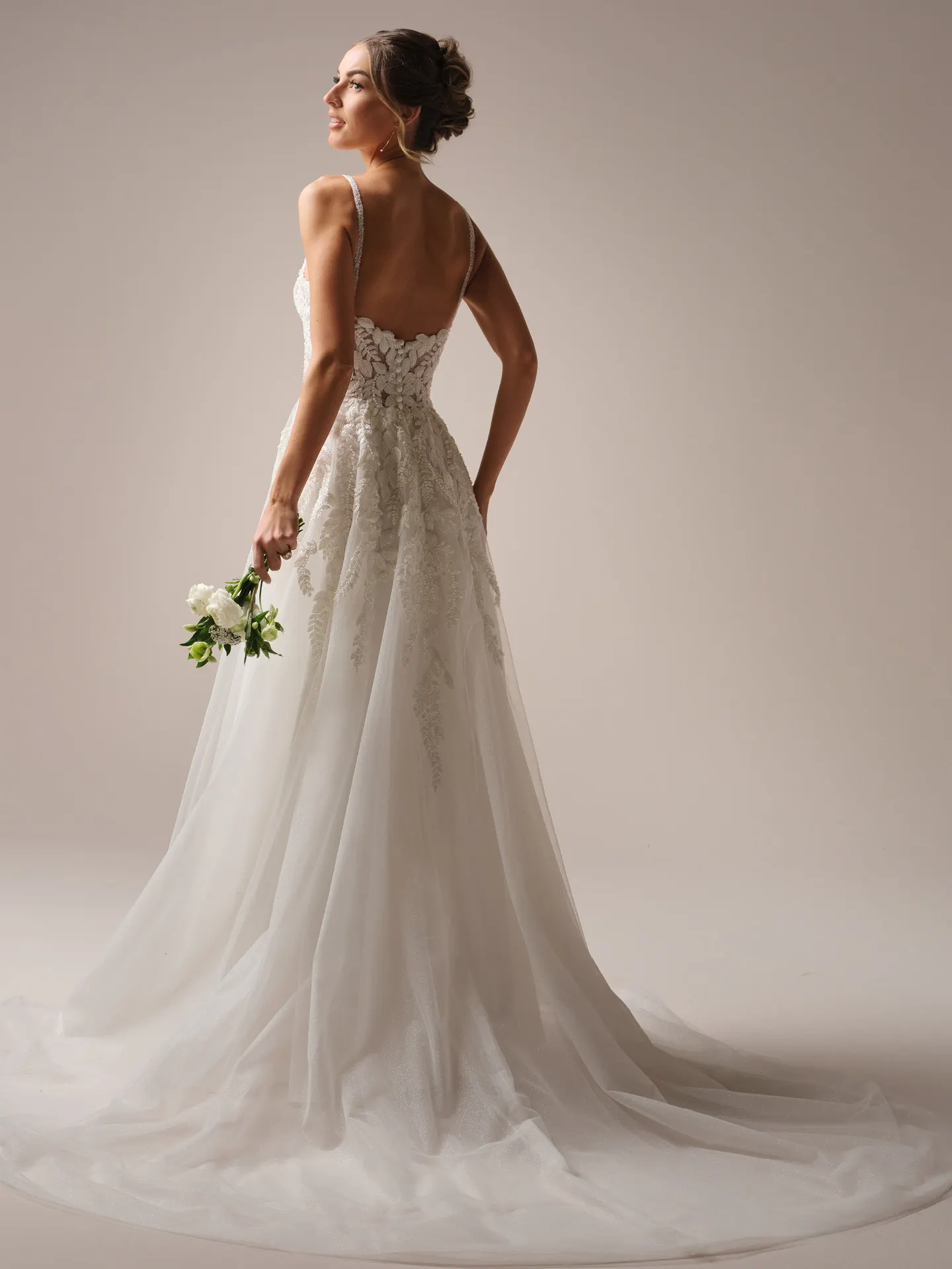 Rebecca Ingram Carmen back view, A-line wedding gown with lace details and spaghetti straps.
