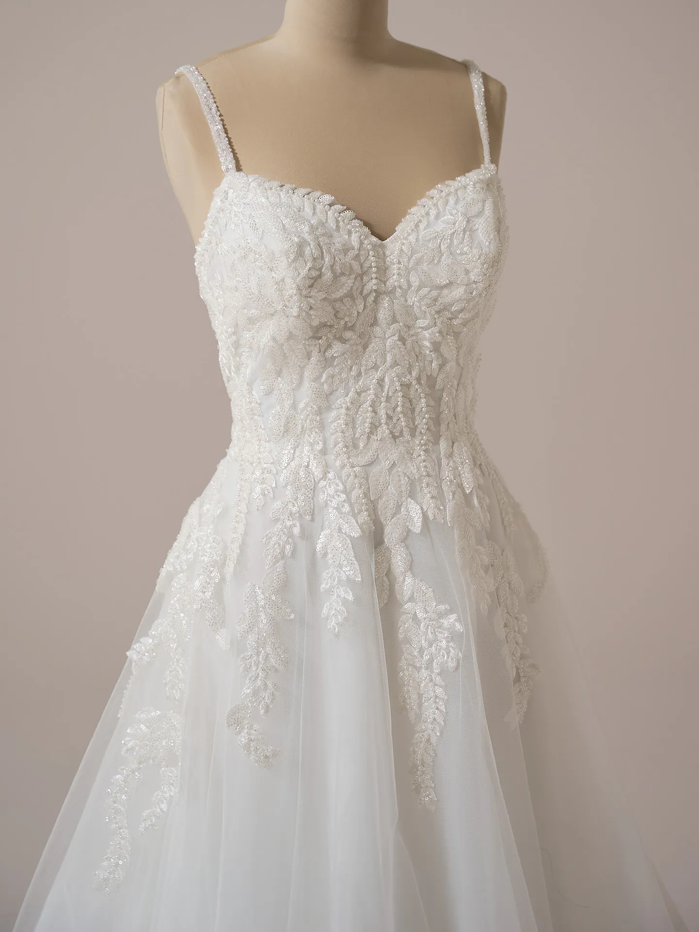 Rebecca Ingram Carmen front view, V-neck A-line gown with lace details.