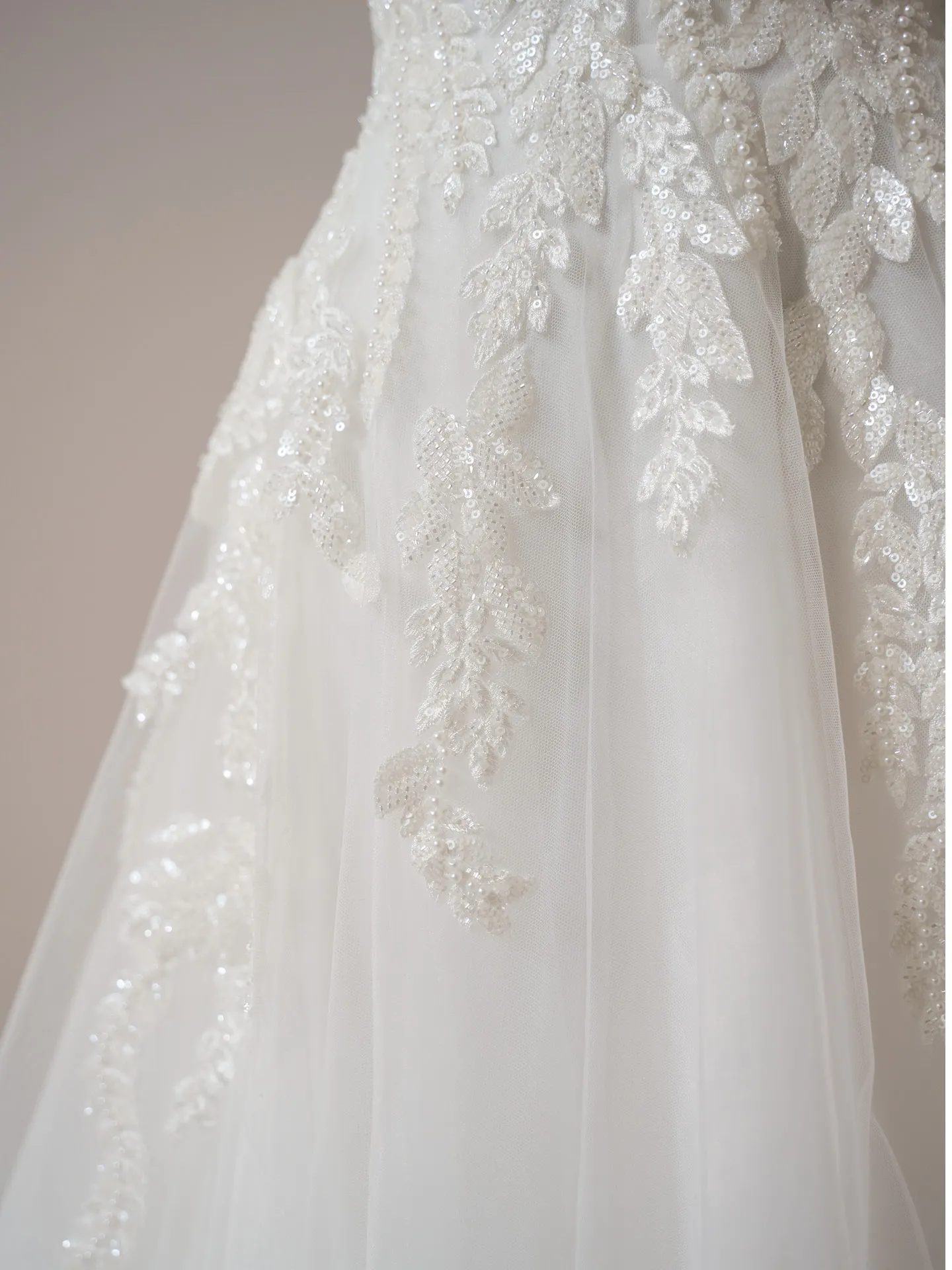 Rebecca Ingram Carmen gown close-up, sequin leaf lace on tulle.