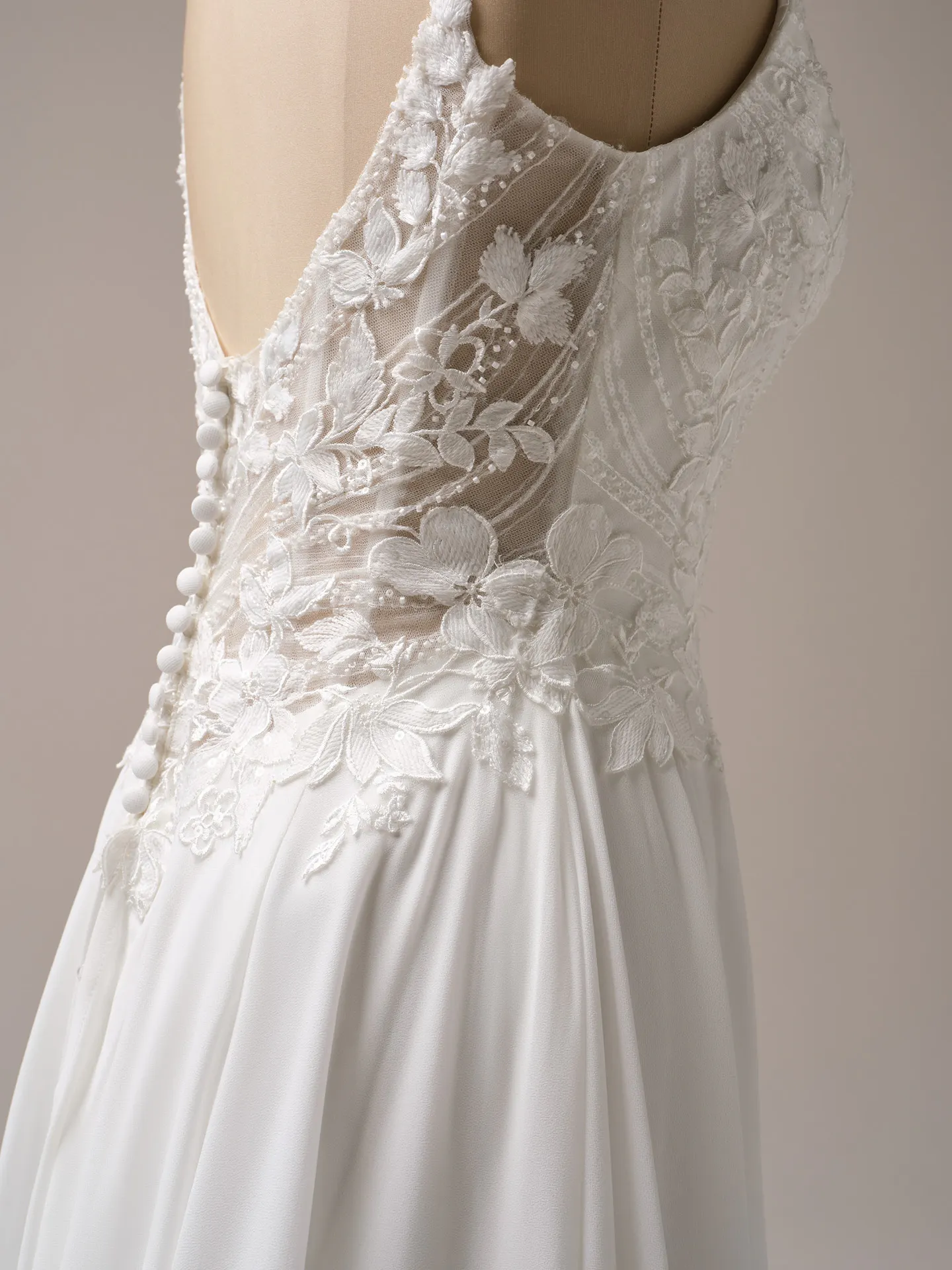 Rebecca Ingram Finley side view lace and buttons detail on A-line gown.