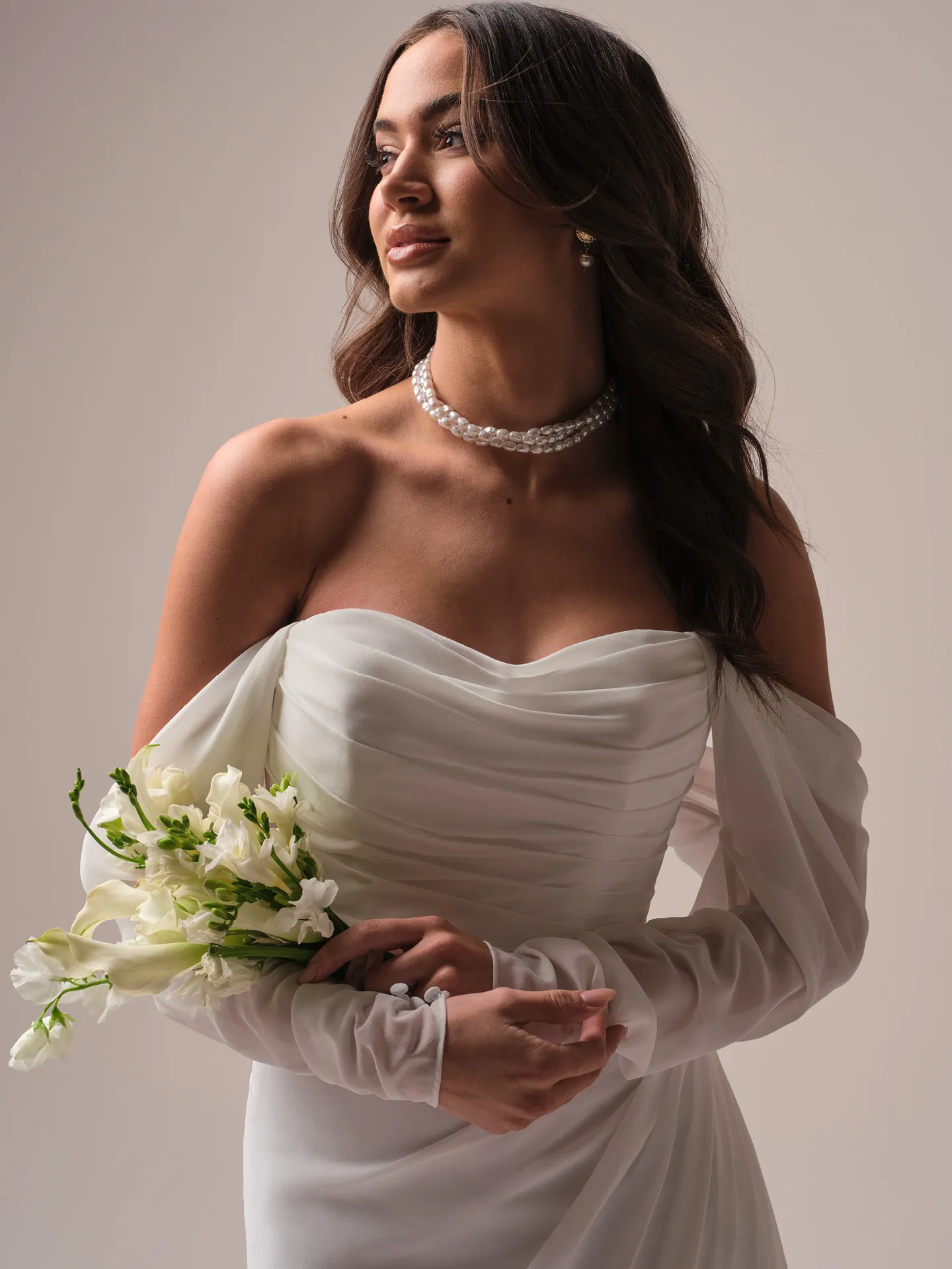 Rebecca Ingram Francesca front view with off-shoulder chiffon sheath dress and bouquet