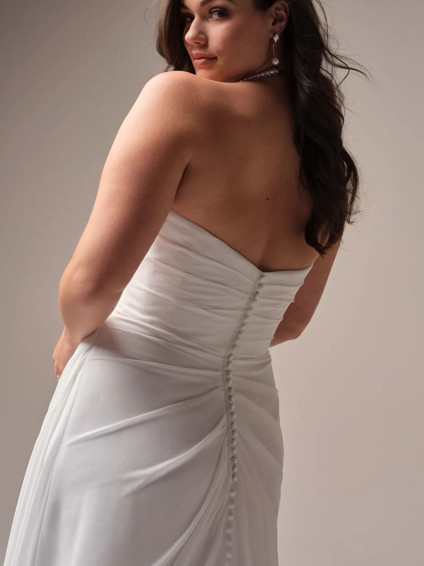 Rebecca Ingram Francesca back view satin wedding dress with button detail.