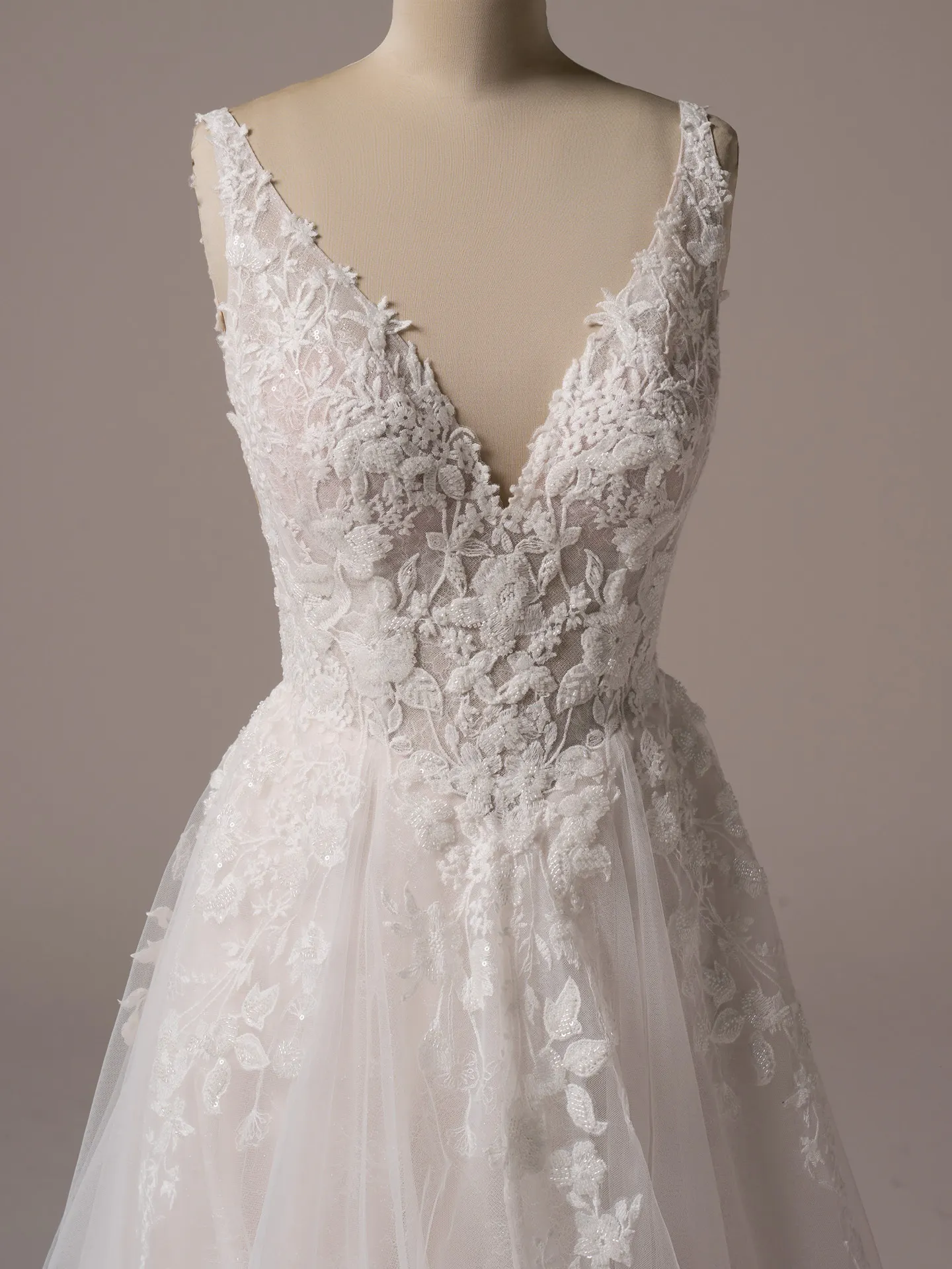 Rebecca Ingram Honor front view, beaded lace V-neck details, flowy A-line skirt.
