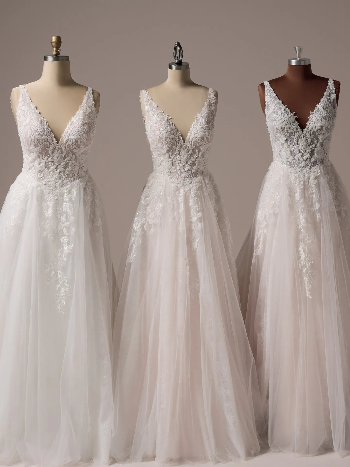 Rebecca Ingram Honor A-line bridal gown with beaded V-neck, front view on mannequins.