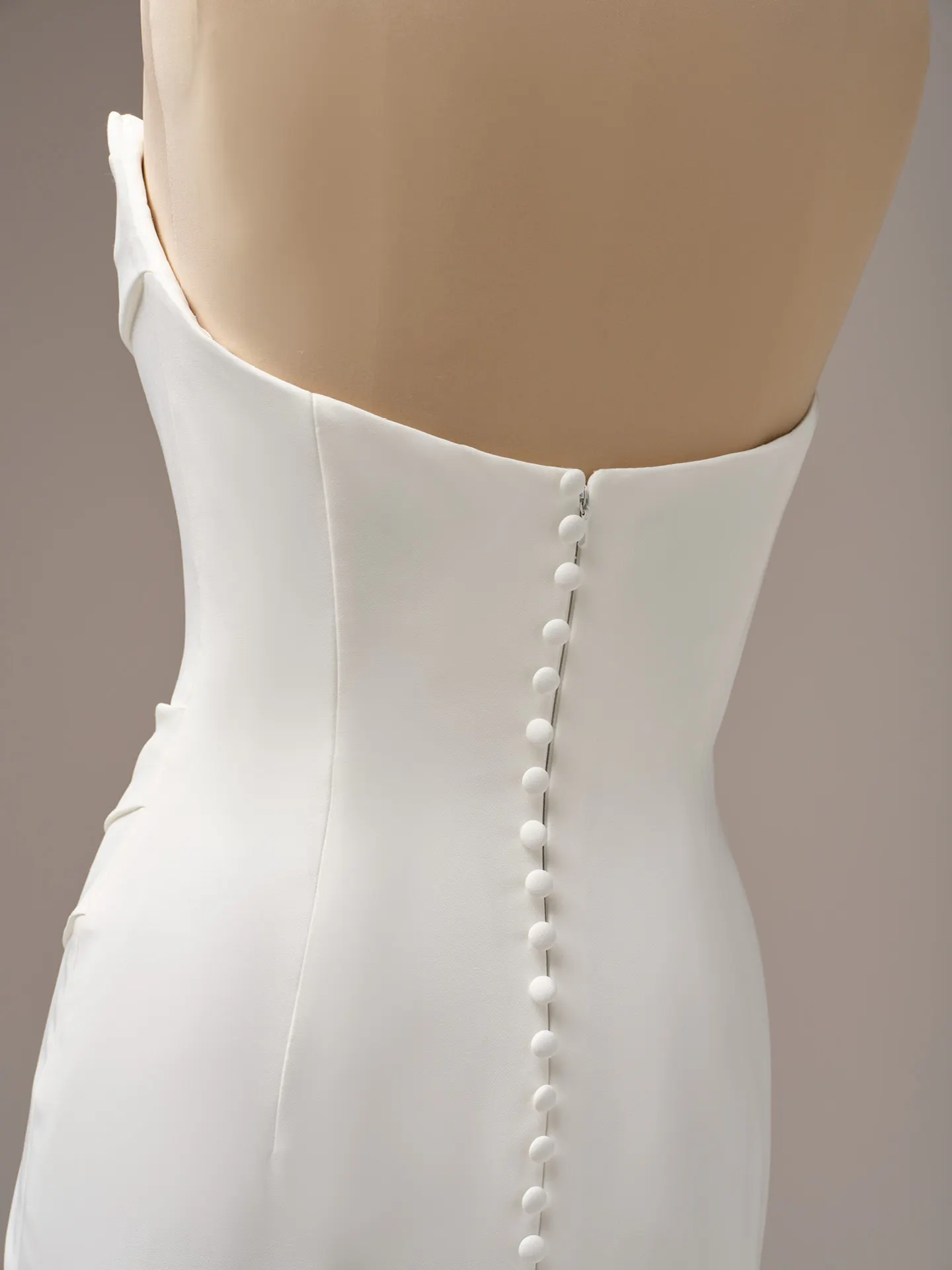 Kailani back view showing buttons on crepe fabric Maggie Sottero