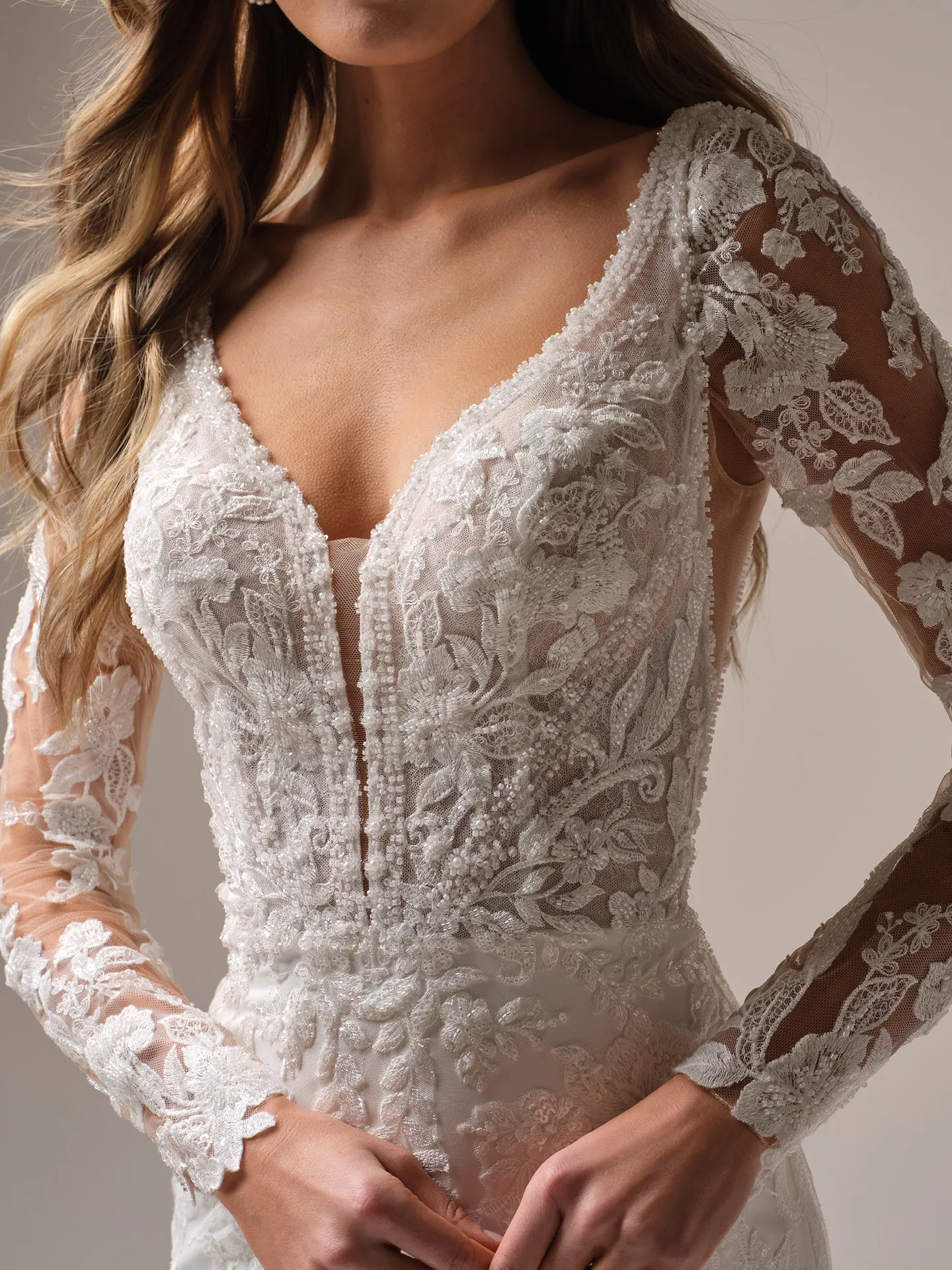 Rebecca Ingram Larissa front view, deep-V lace fit-and-flare, detailed long sleeves.
