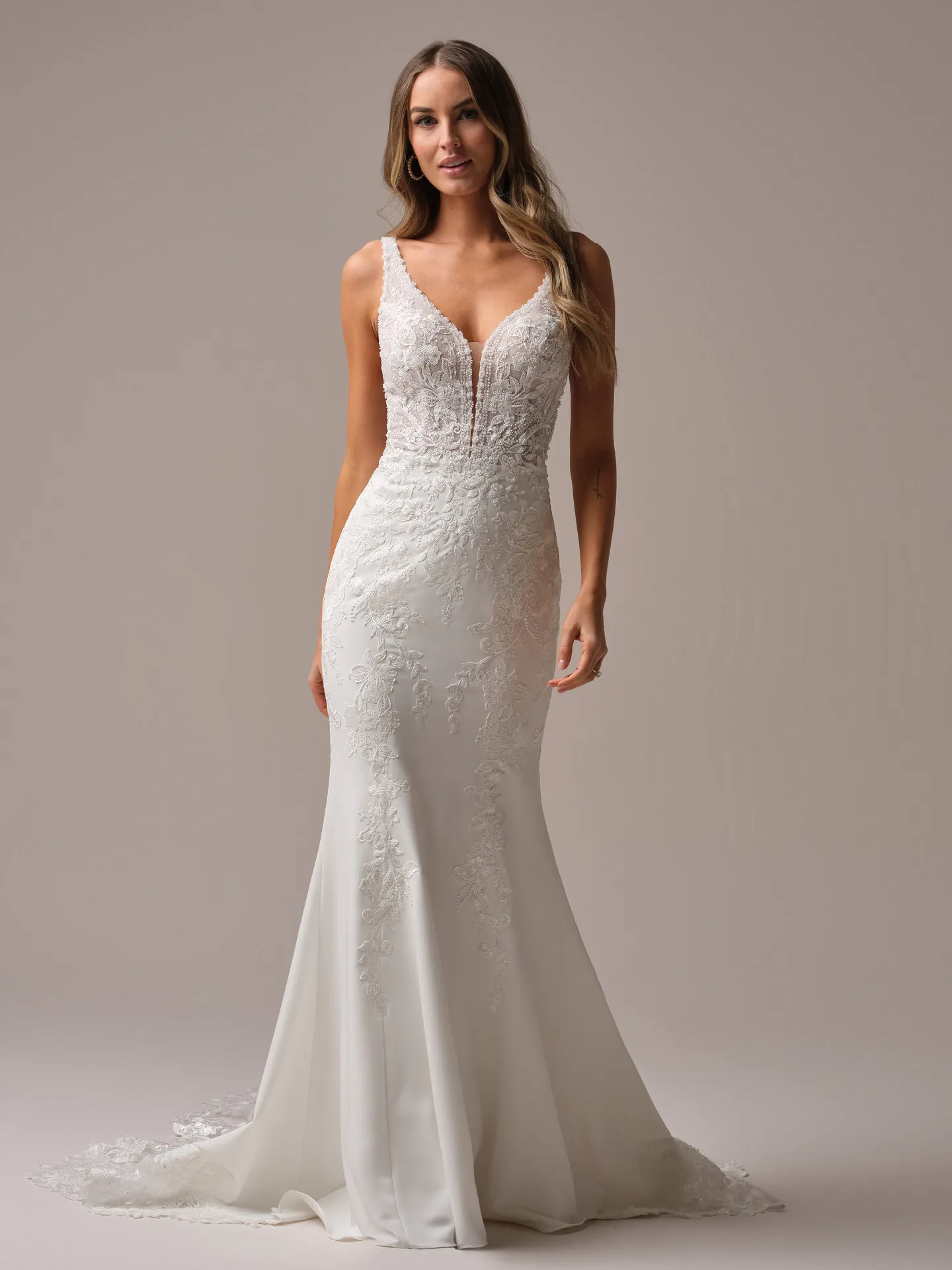 Rebecca Ingram Larissa front view deep-V fit-and-flare bridal gown with lace details.