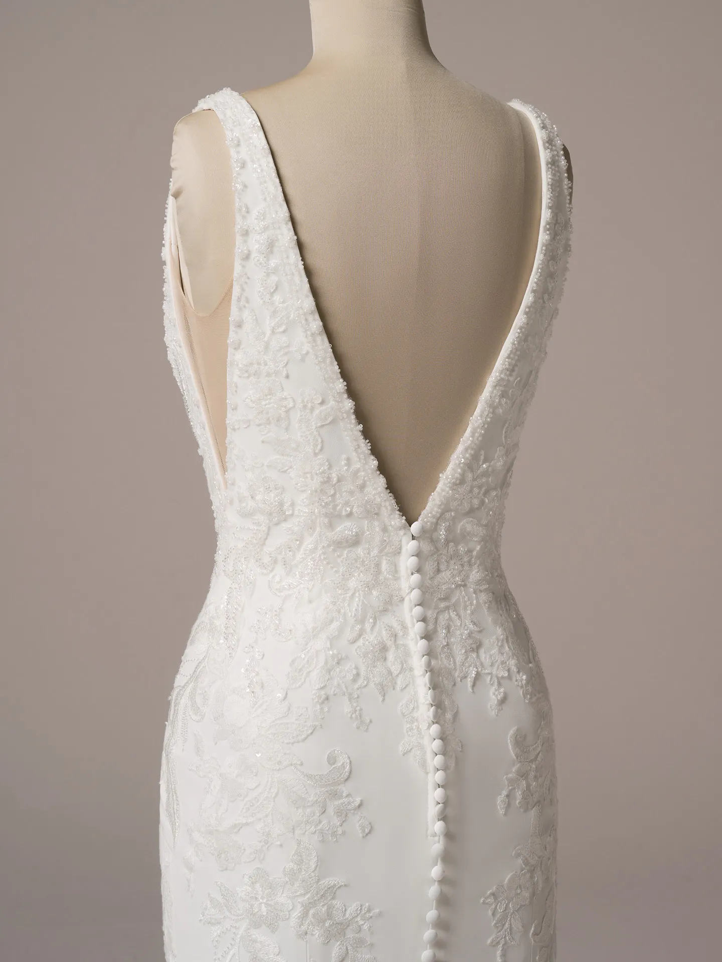 Rebecca Ingram Larissa back view with deep V and detailed lace on fit-and-flare bridal gown.