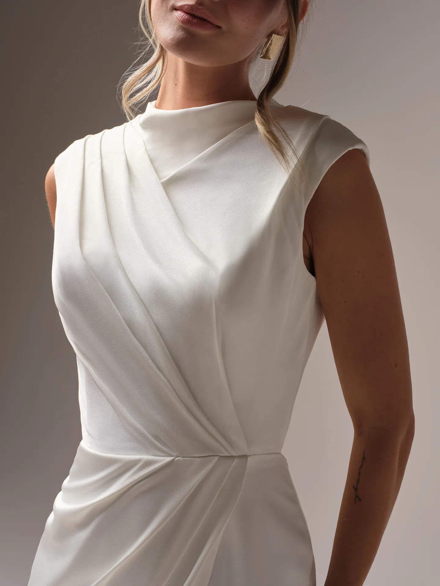 Rebecca Ingram Portia high-neck modern sheath wedding dress in Trento satin with modest cap sleeves and V-back.