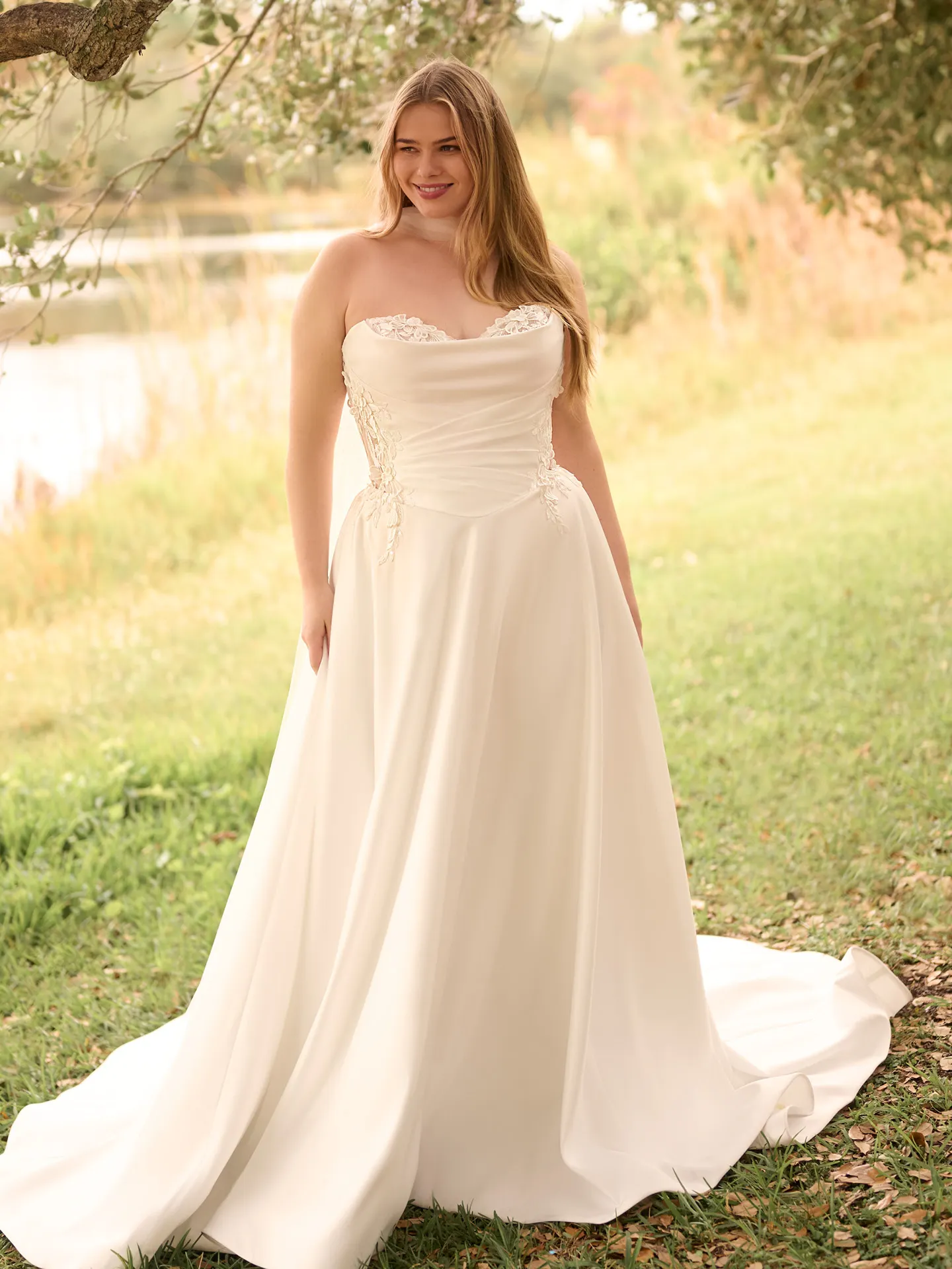 Rebecca Ingram A-line gown front view in a garden setting.