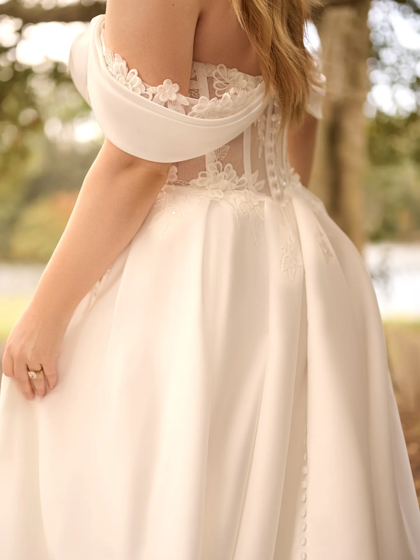 Rebecca Ingram Sable back view floral sweetheart A-line buttons outdoor setting.