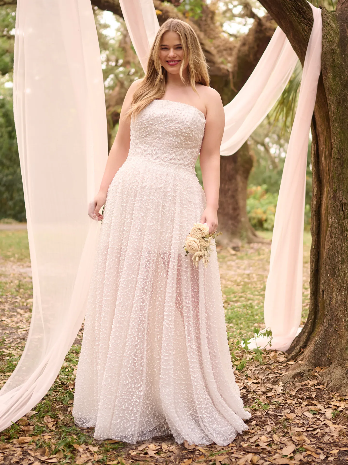 Rebecca Ingram Taylor strapless beaded bridal dress front view in garden setting