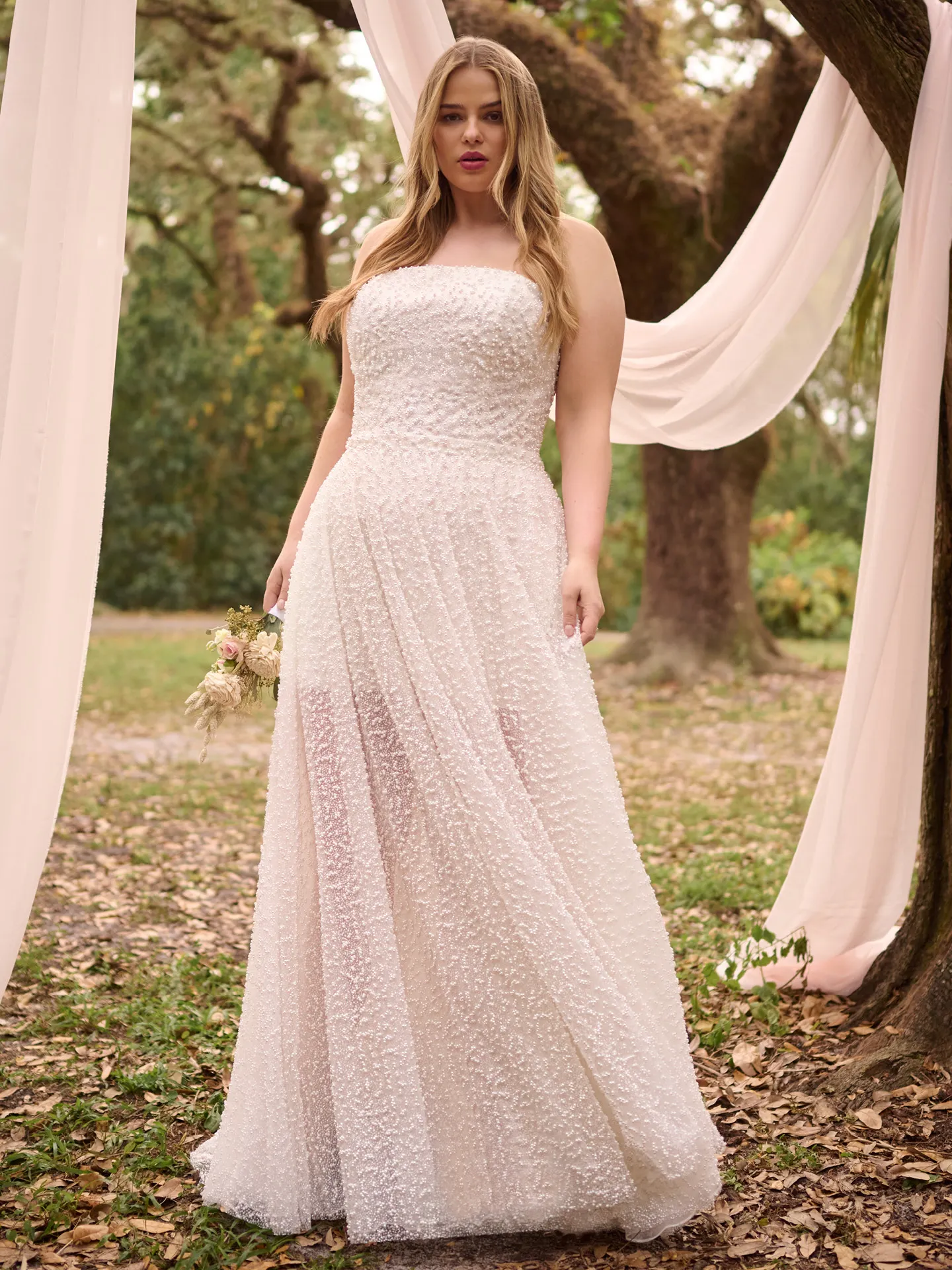 Rebecca Ingram Taylor strapless beaded bridal dress front view in woodland setting.