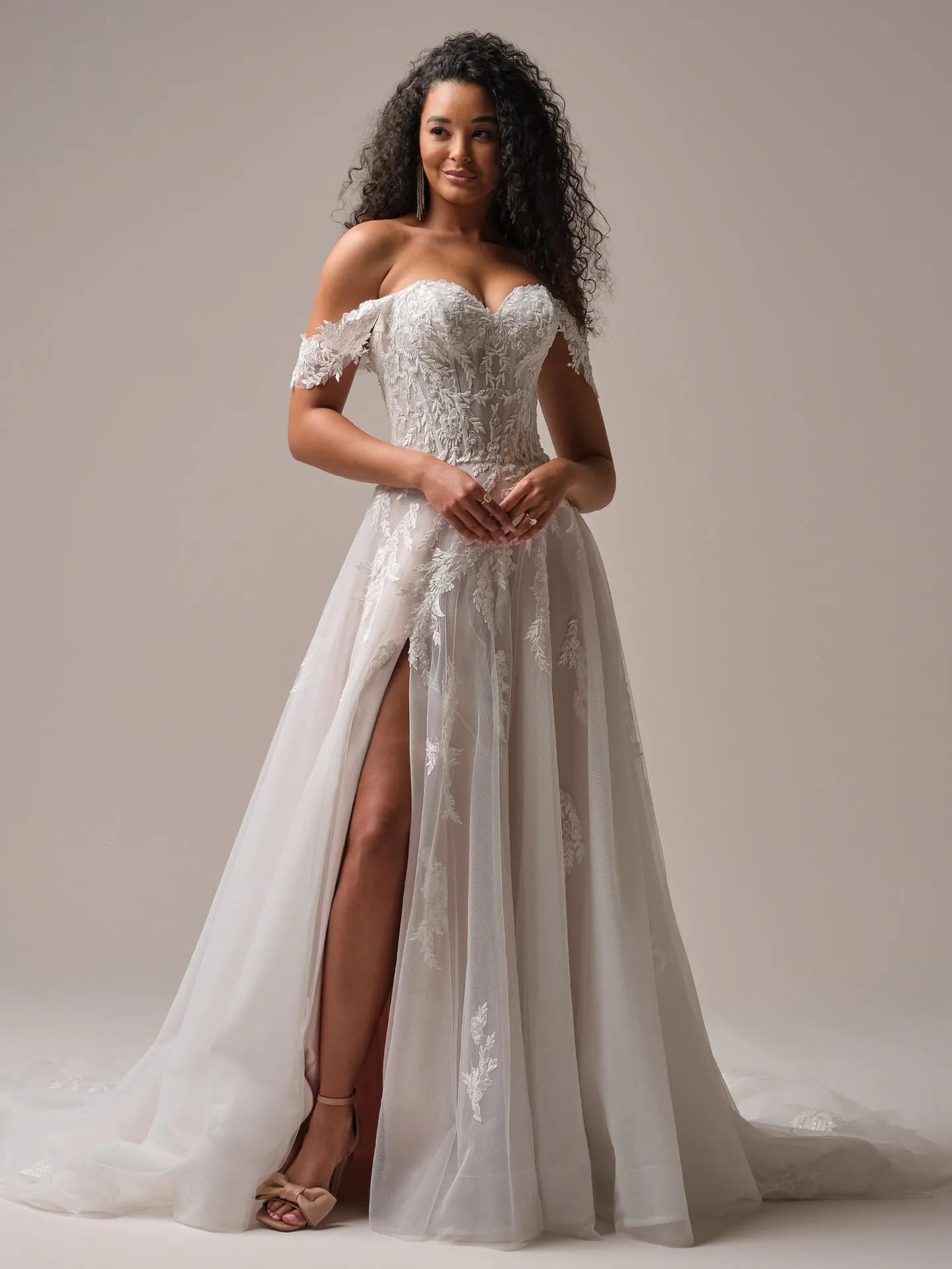 Rebecca Ingram Victoria front view; floral lace A-line with slit.