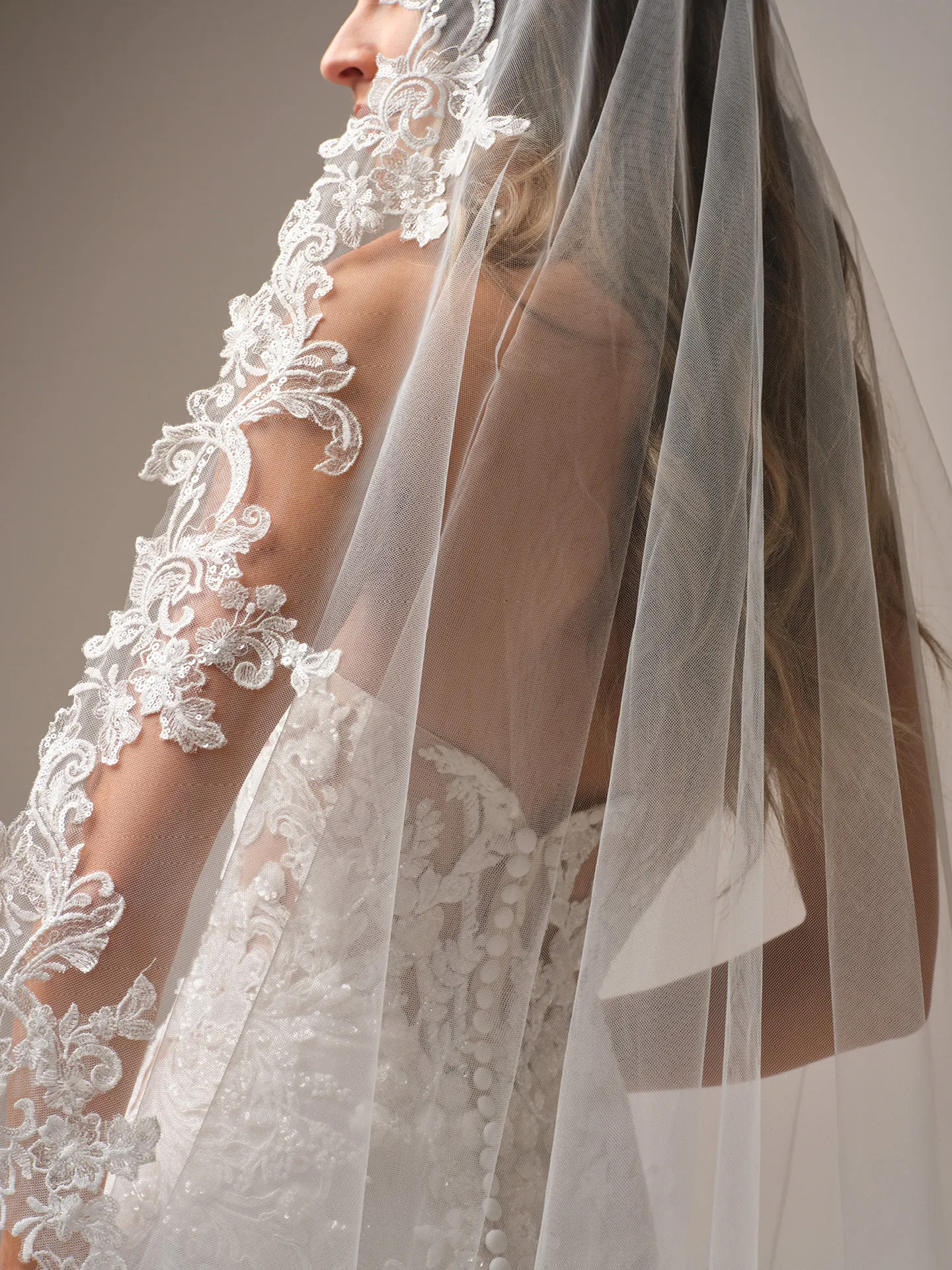 Sottero and Midgley Halle fit and flare wedding dress back angle with train gathered closer