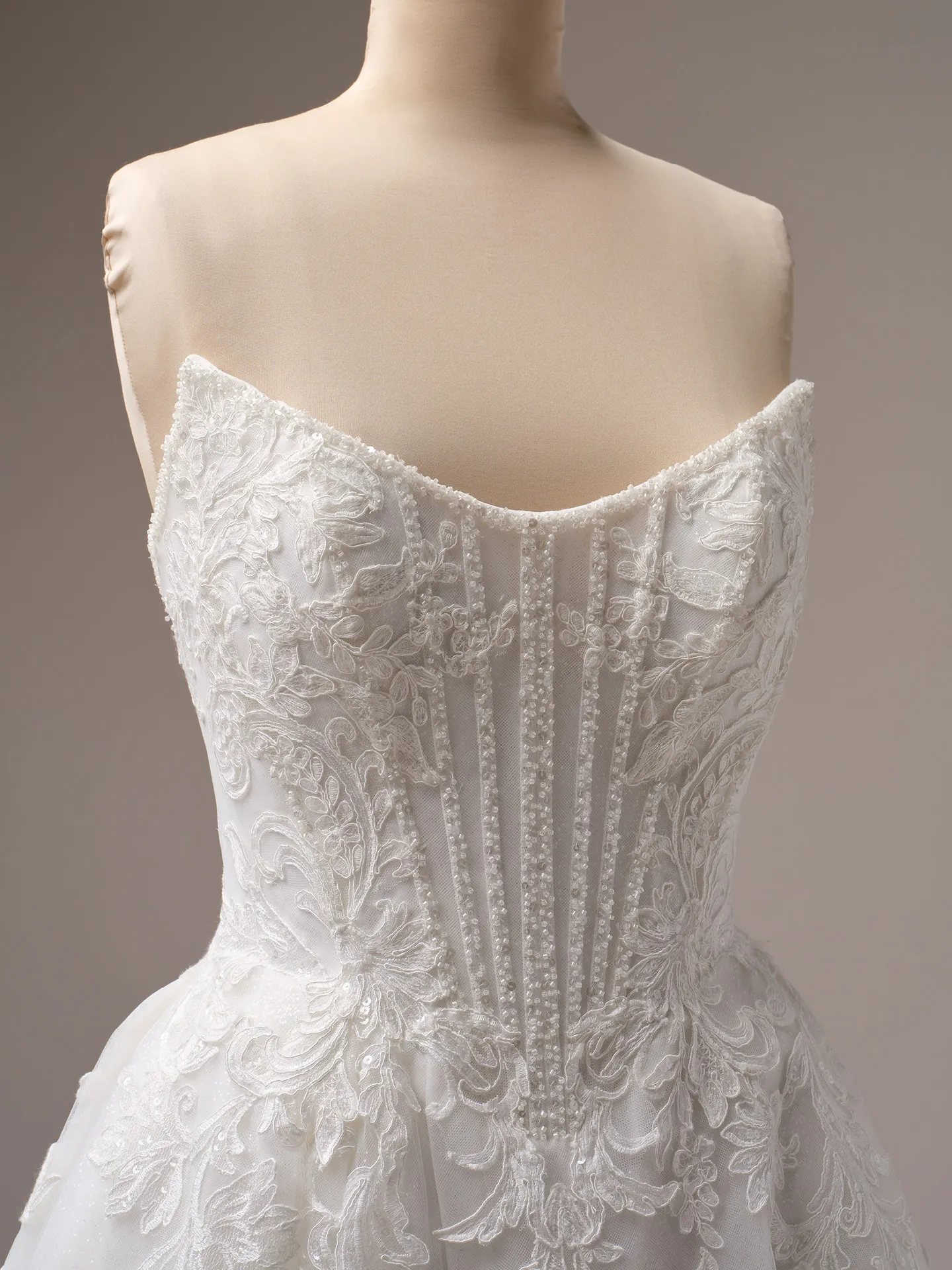 Sottero and Midgley Parker A-line gown front view with exposed boning and lace detailing