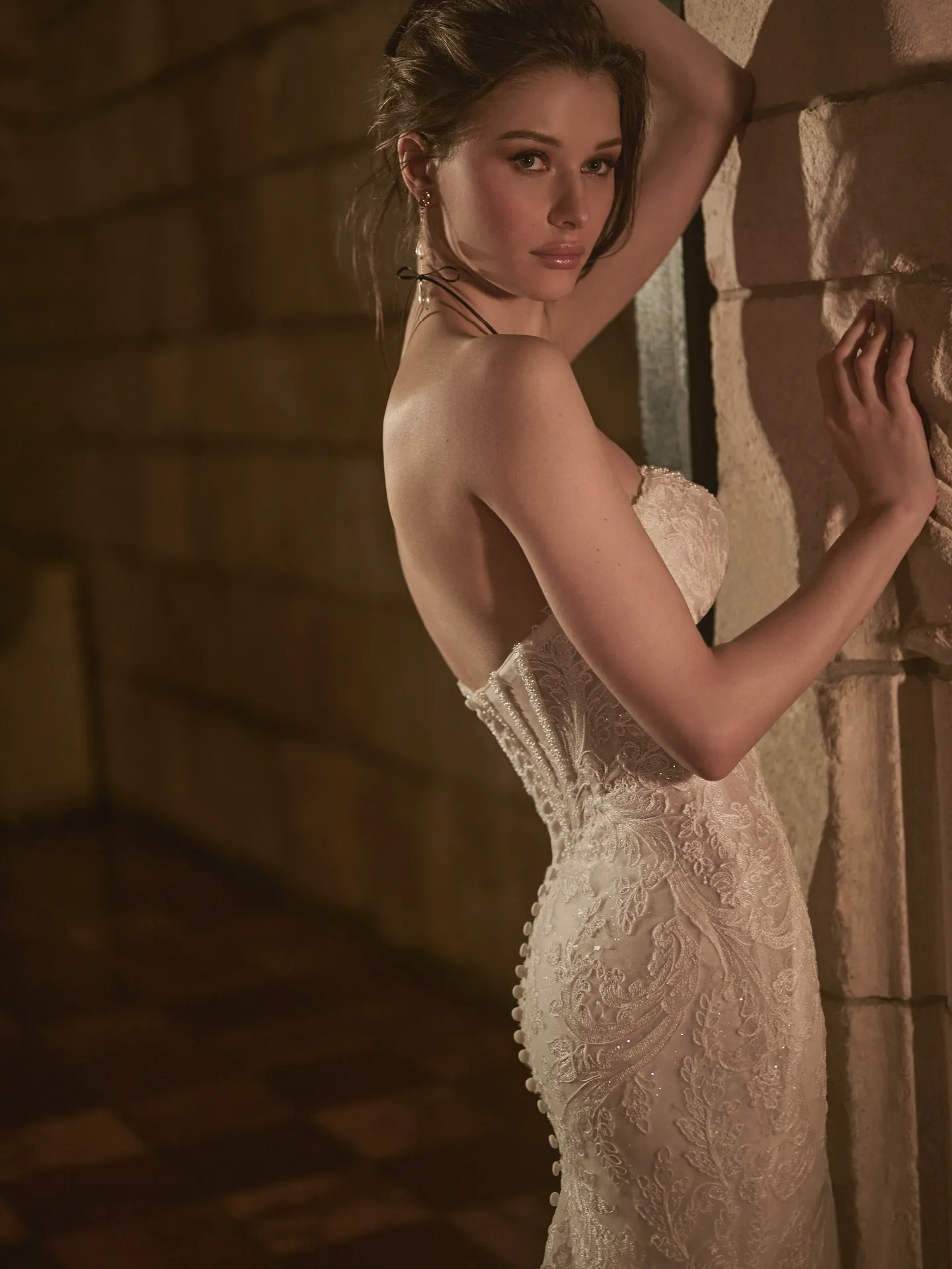 Sottero and Midgley Zareen side view lace mermaid dress against a stone wall