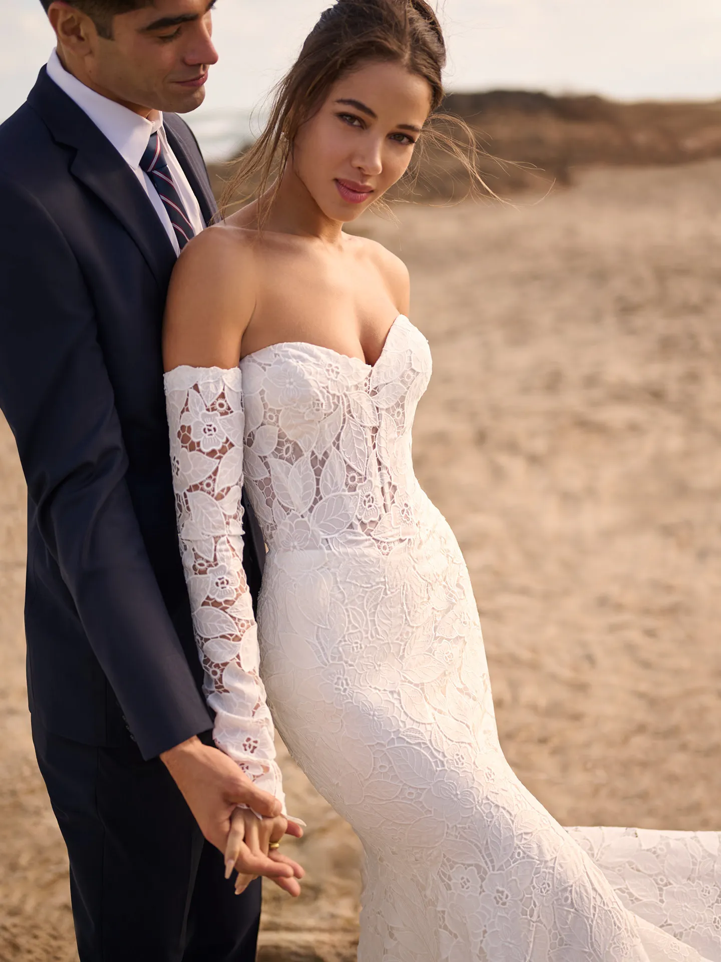 Maggie Sottero Dakota lace long-sleeve wedding dress front view on a beach