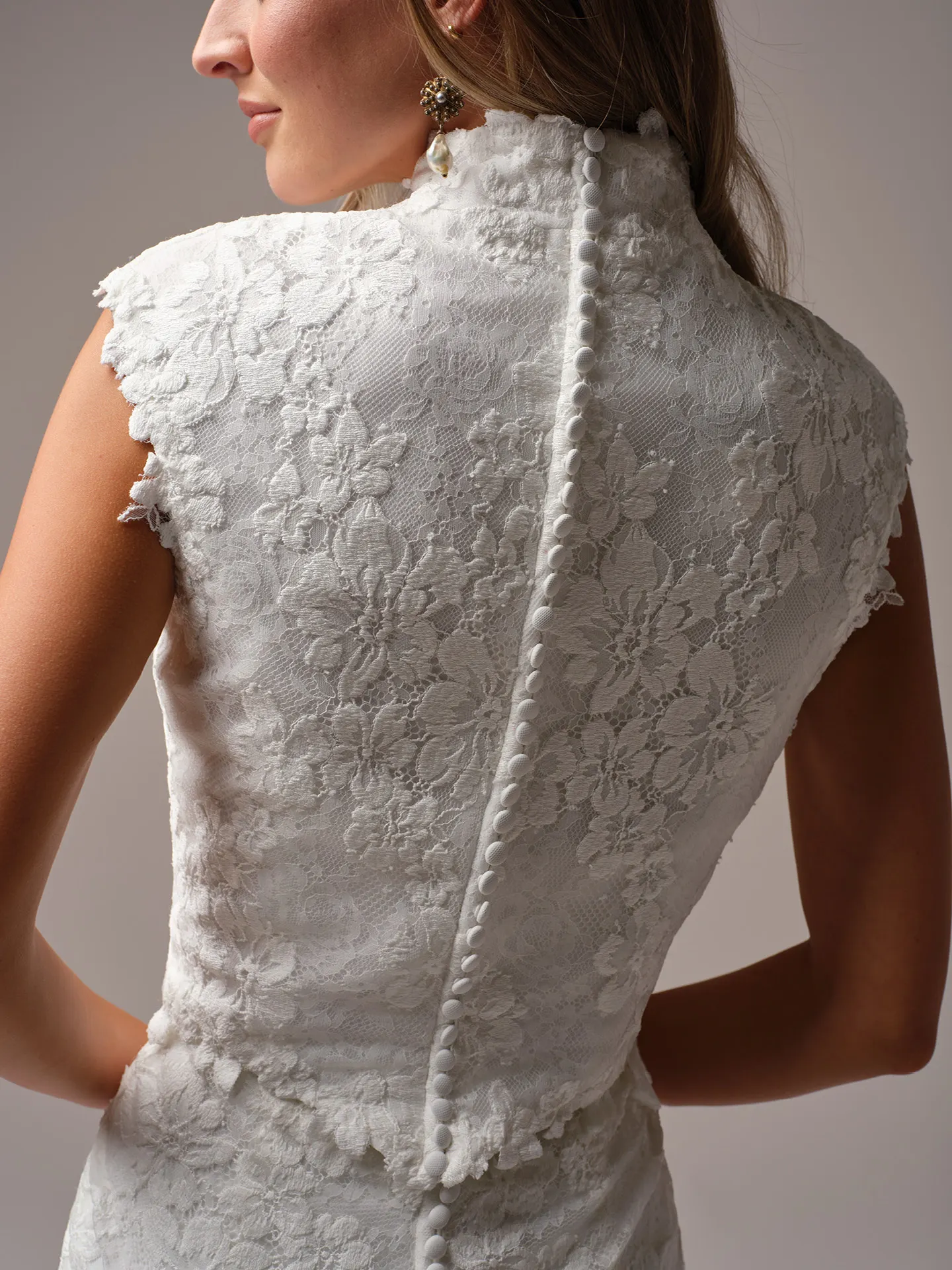 Maggie Sottero Devon Modest lace jacket back view with cap-sleeves and button detail