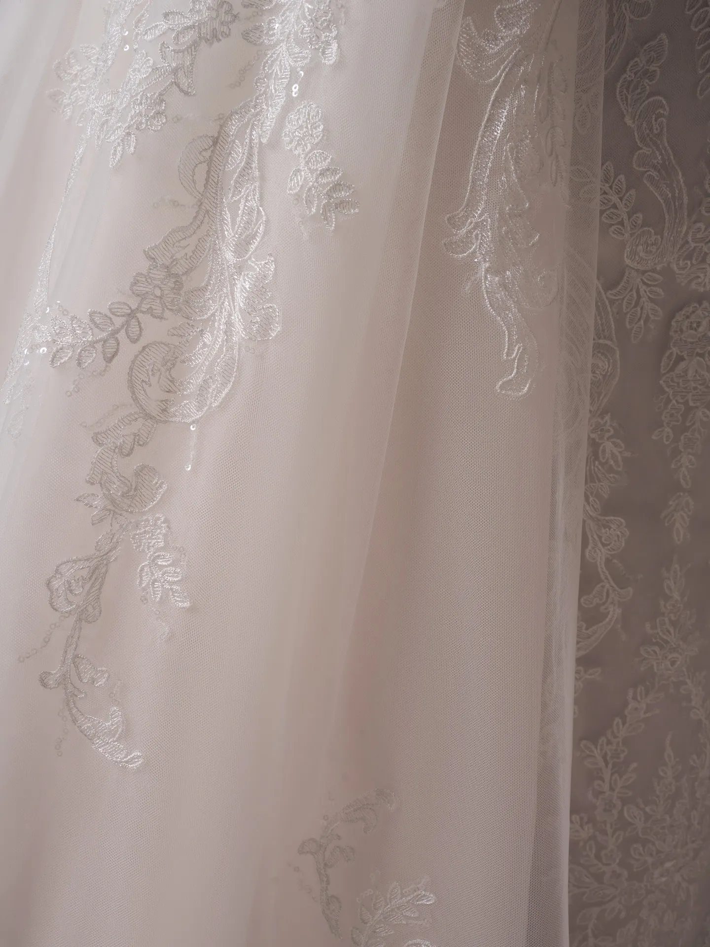 Zareen train with beaded lace over plain tulle by Sottero and Midgley.