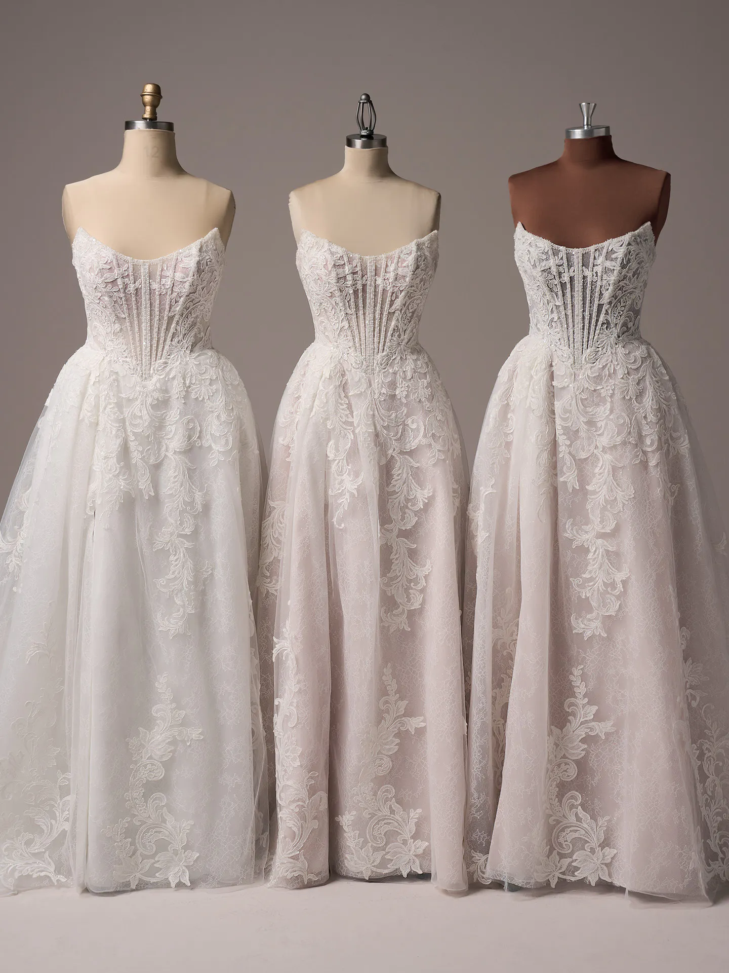 Sottero and Midgley Parker front view glittering A-line gown with exposed boning on mannequins