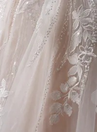 Maggie Sottero Liberty ballgown wedding dress angled side with layered skirt