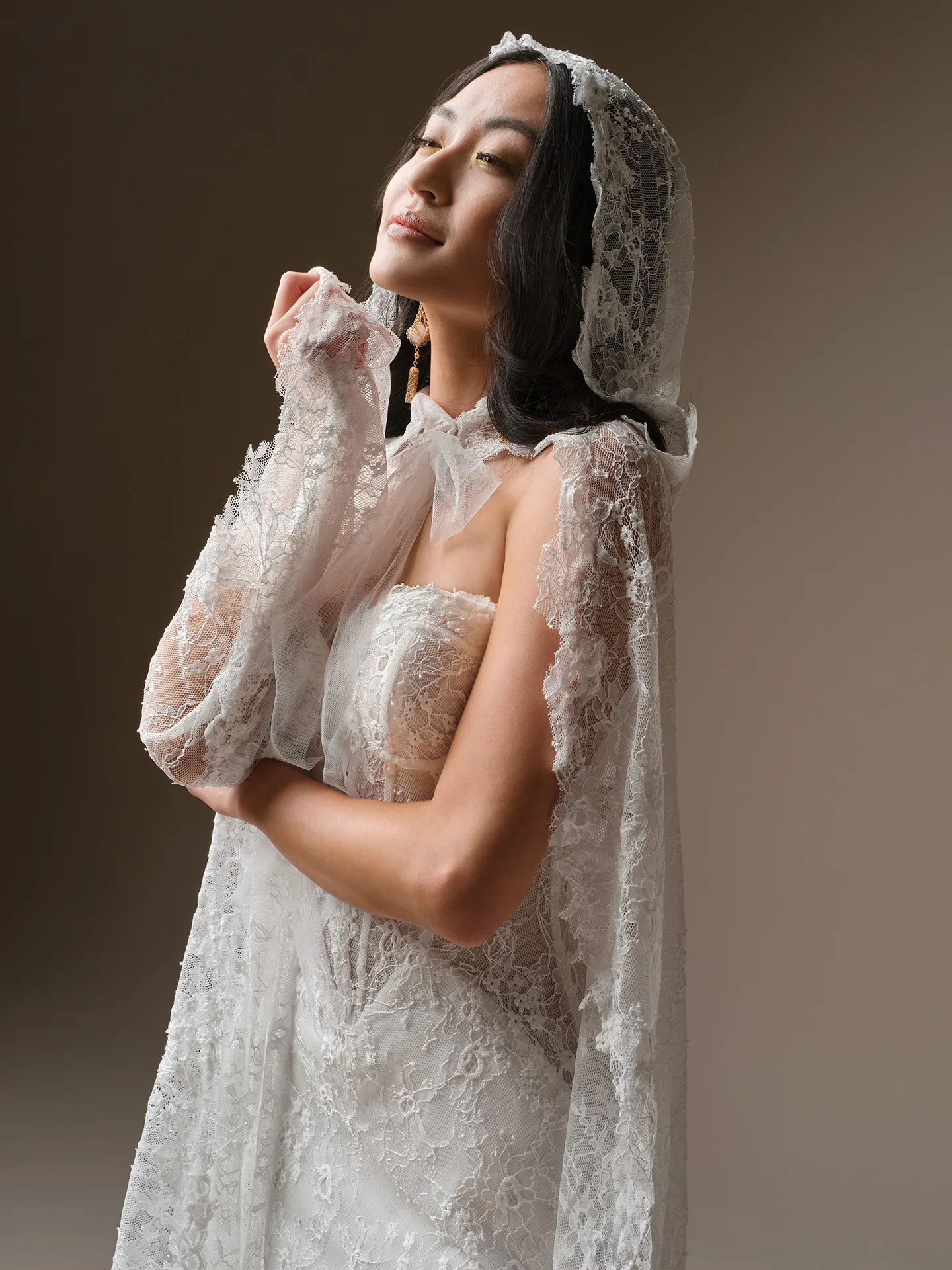 Maggie Sottero Bellevue, side view, lace mermaid dress with strapless design and lace hood.