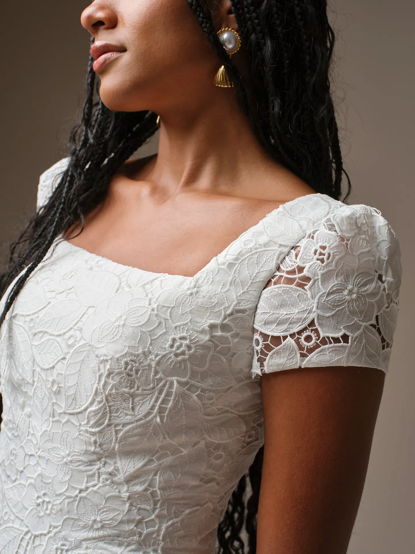 Maggie Sottero Dakota lace dress close-up, showcasing floral detail on bodice and sleeves.