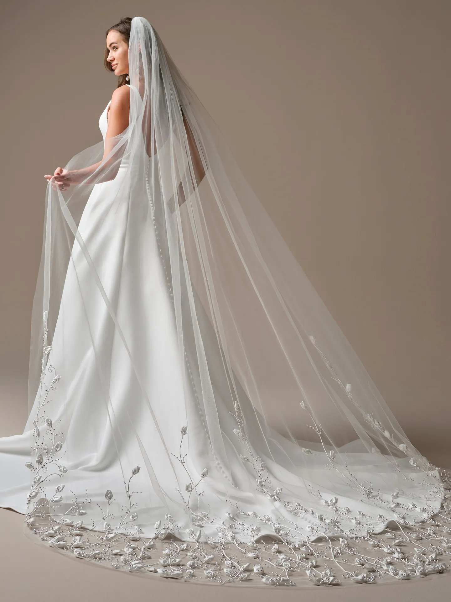 Maggie Sottero Lawrence, back view A-line satin dress with long embroidered veil.
