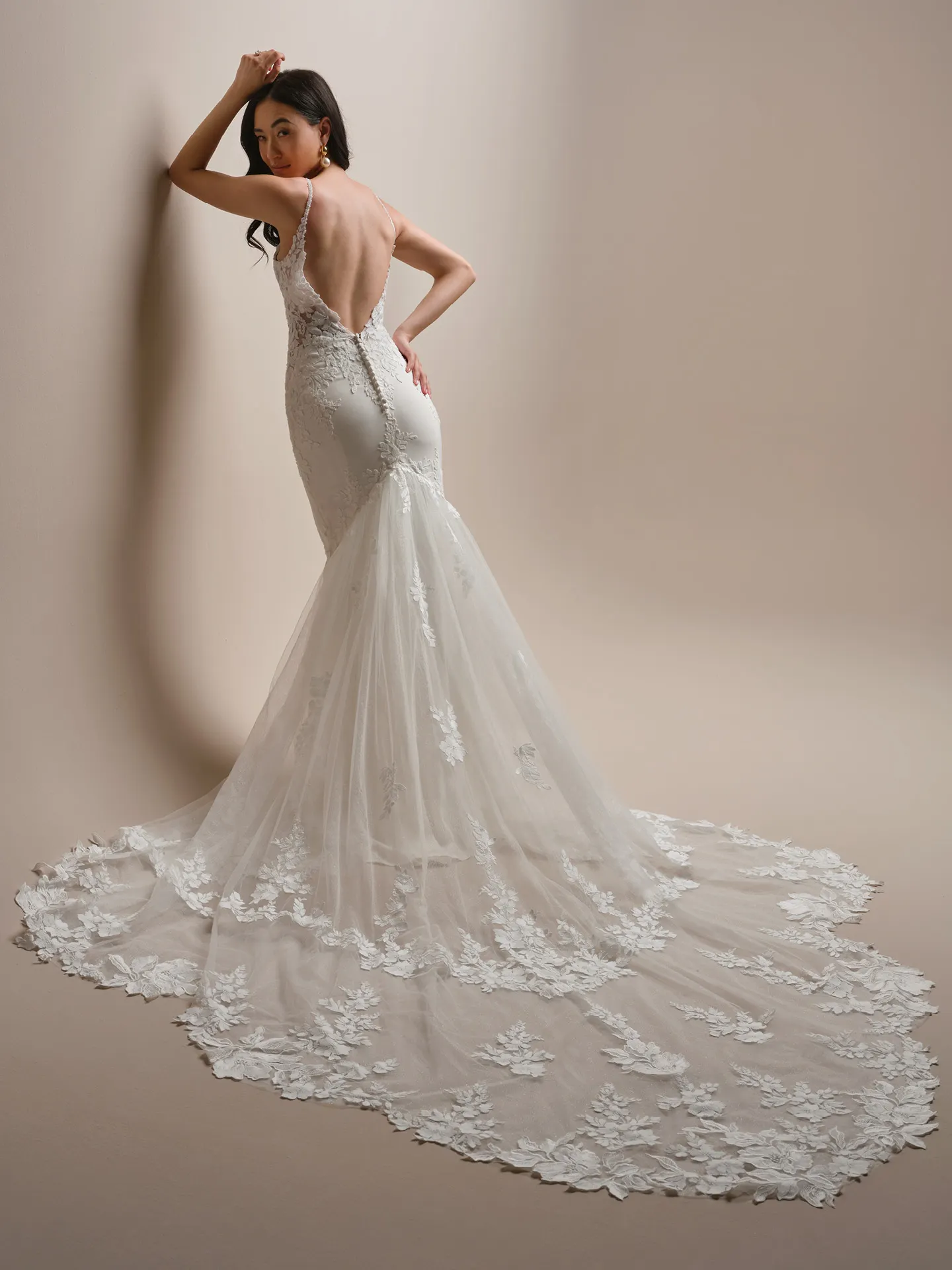 Maggie Sottero Noelle beaded lace sheath gown, back view with long floral train.