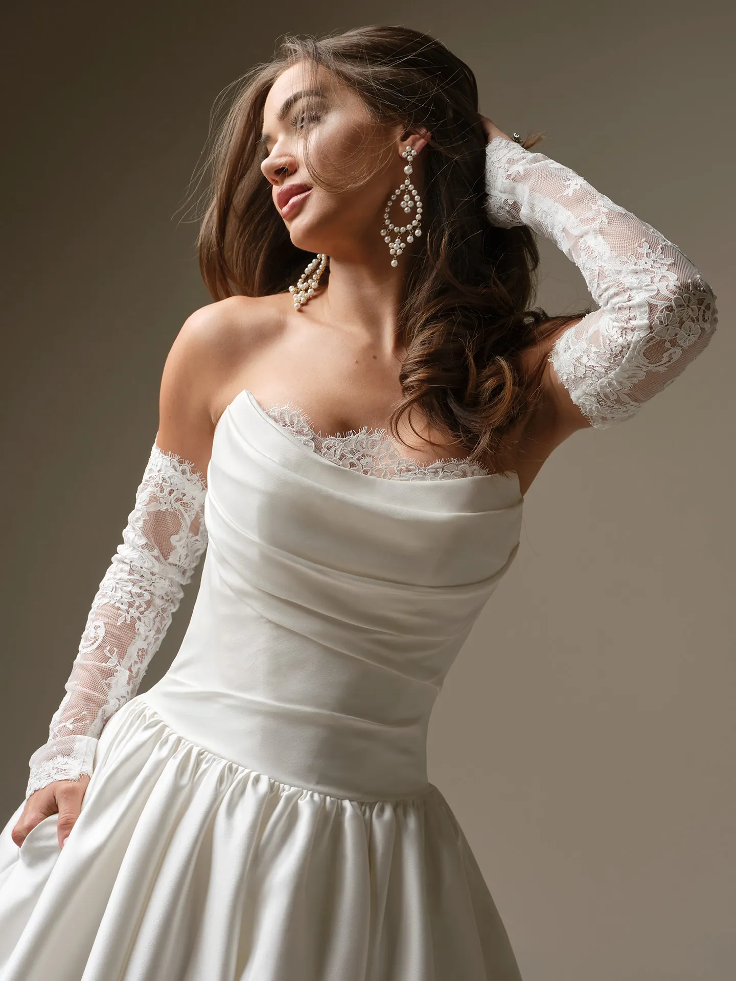 Maggie Sottero Sylvana satin A-line dress, front view Maggie Sottero with lace sleeves and elegant draping.