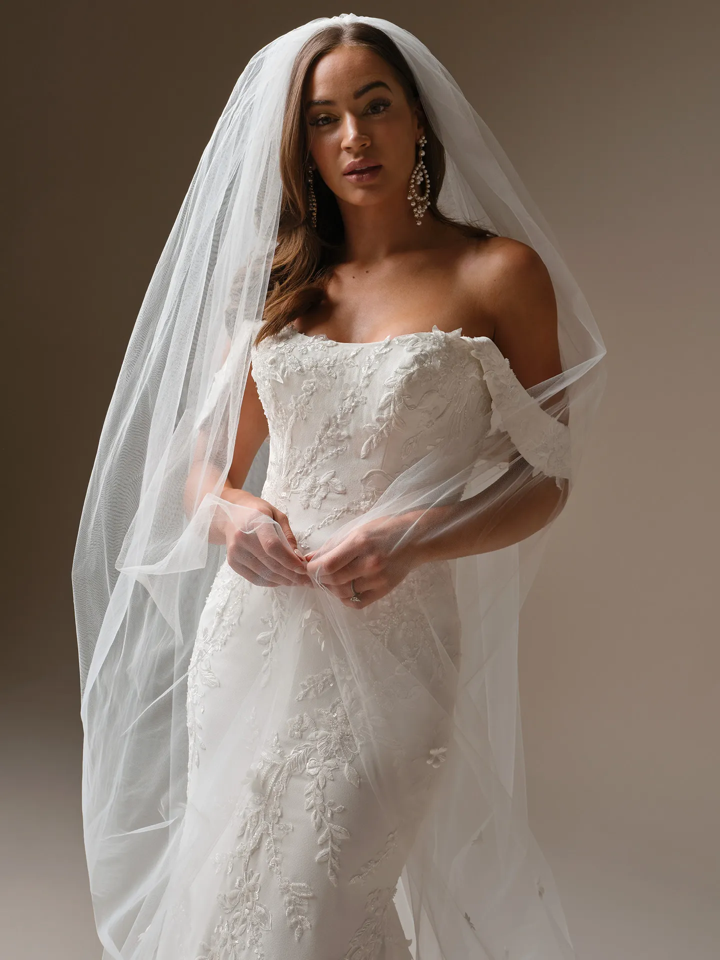Maggie Sottero Thera, front view fit-and-flare wedding dress with lace and veil.