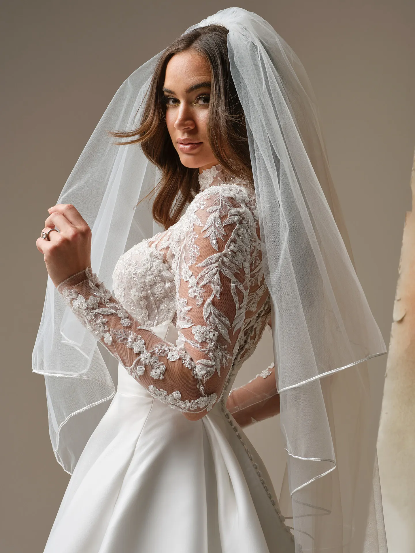 Maggie Sottero Trinity lace sleeve A-Line dress, side view.