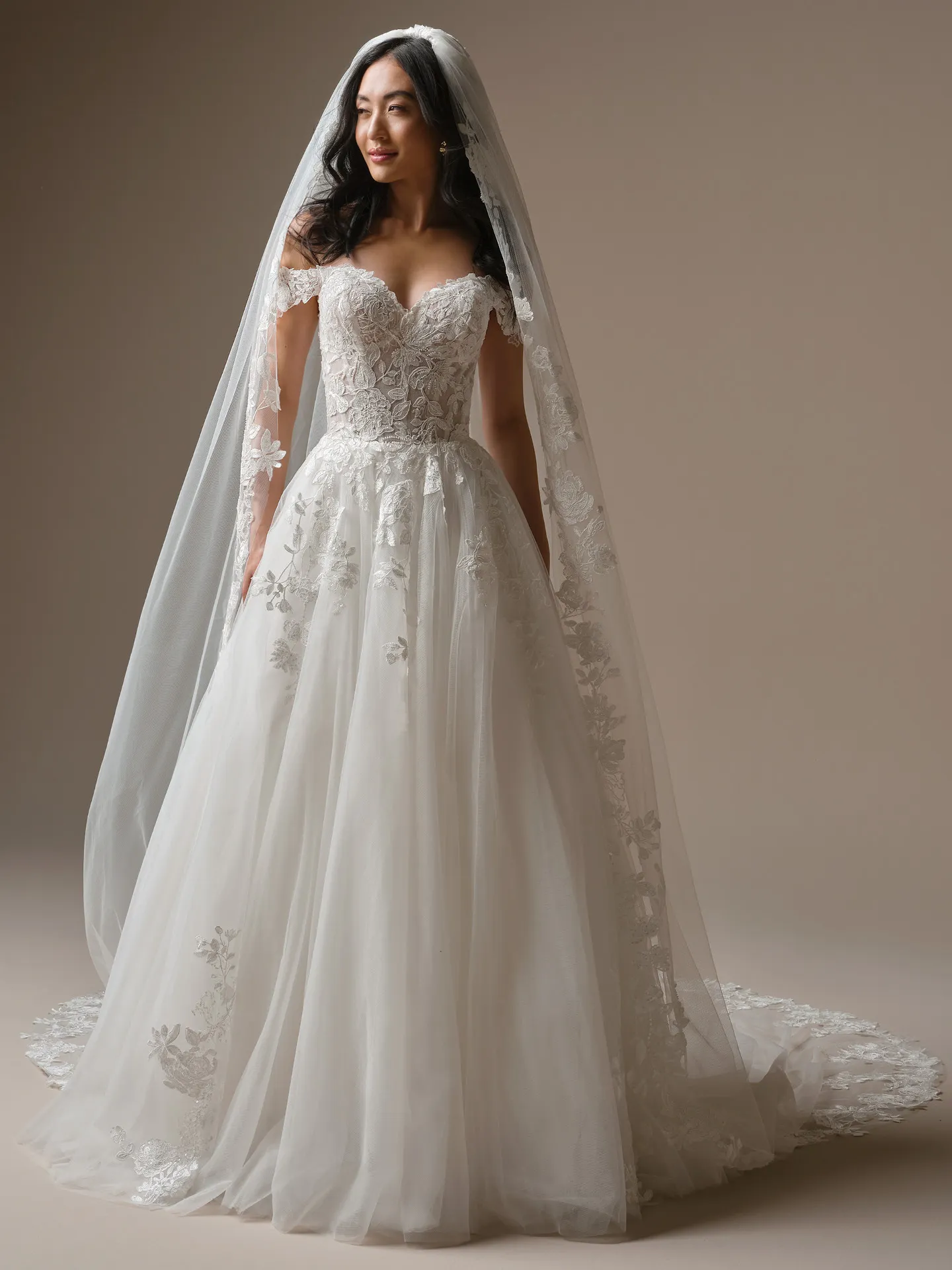 Maggie Sottero Verina, front view: lace A-line wedding dress with off-shoulder design and veil.
