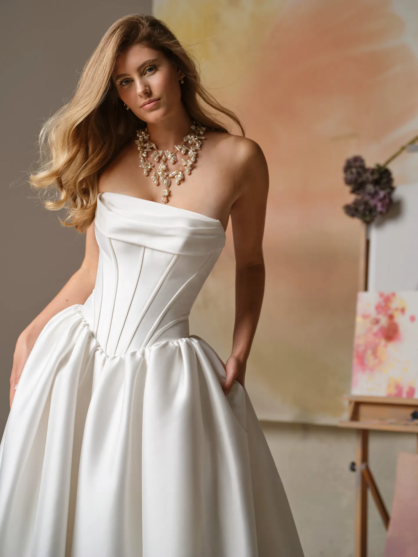 Maggie Sottero Yuma, front view strapless ballgown with cowl neck in studio setting.