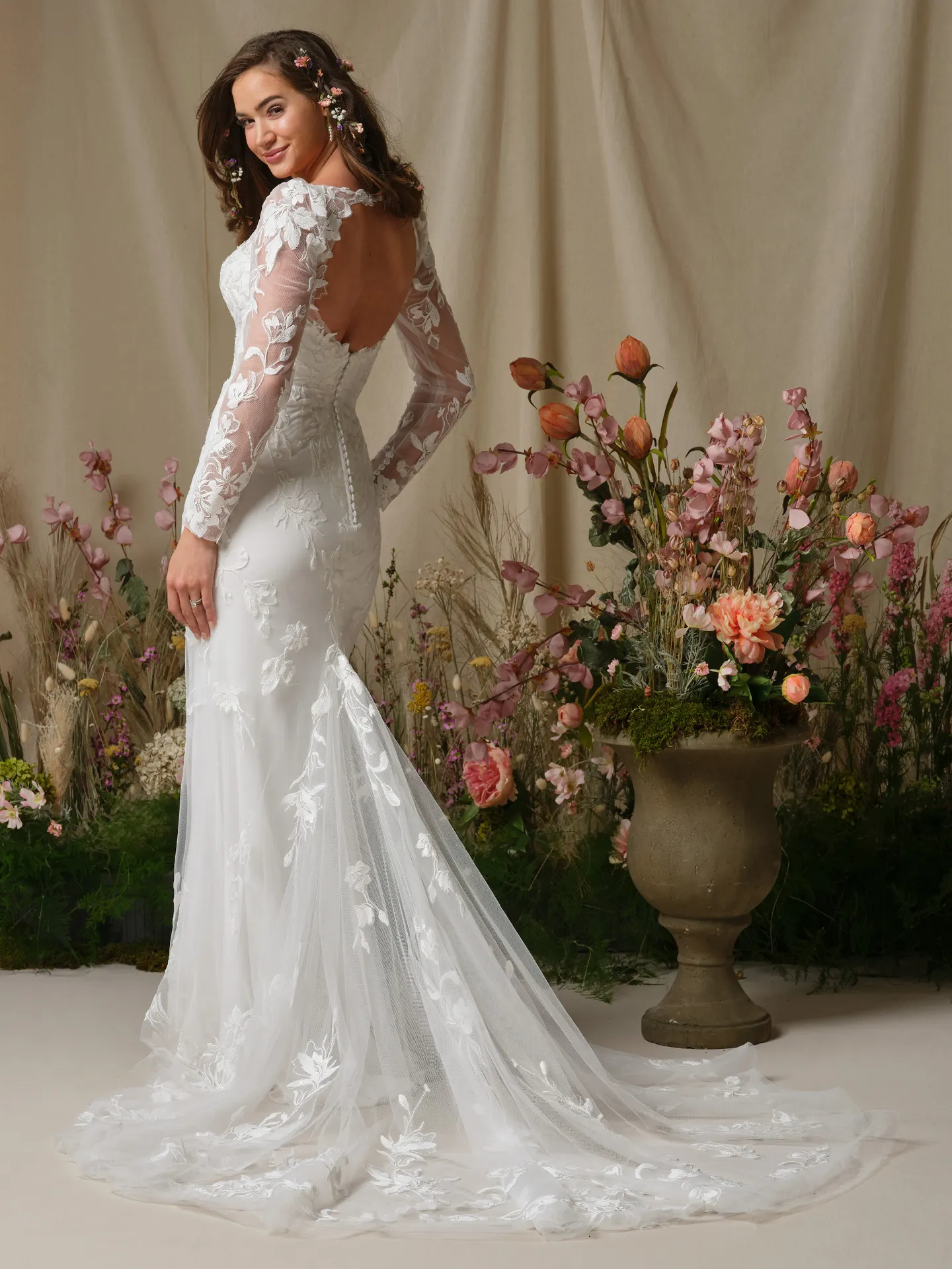 Rebecca Ingram Aubra, back view, fit-and-flare lace wedding dress with keyhole back, floral decor.