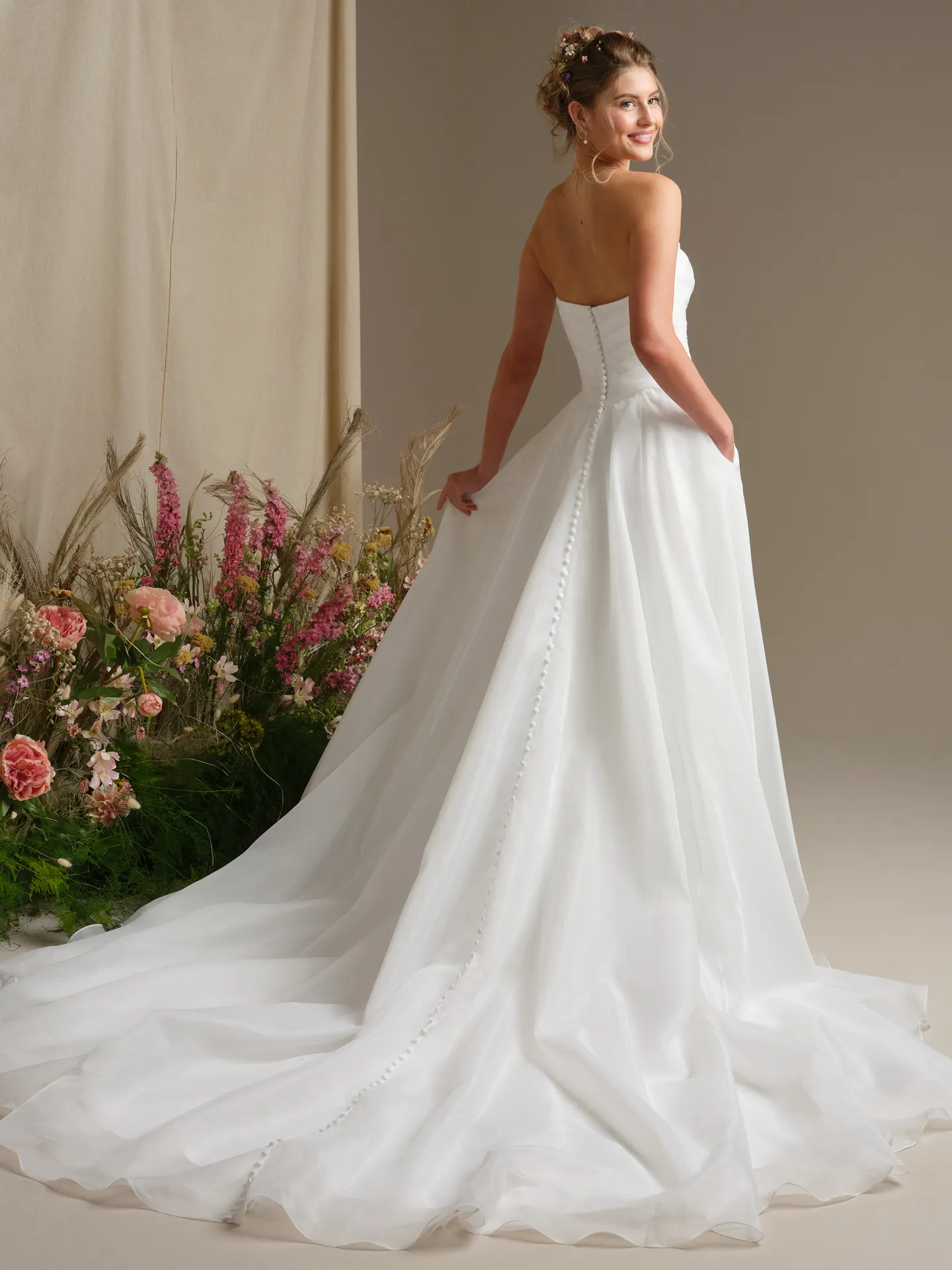 Rebecca Ingram Dezi, back view ballgown dress with button detail and pleated organza.
