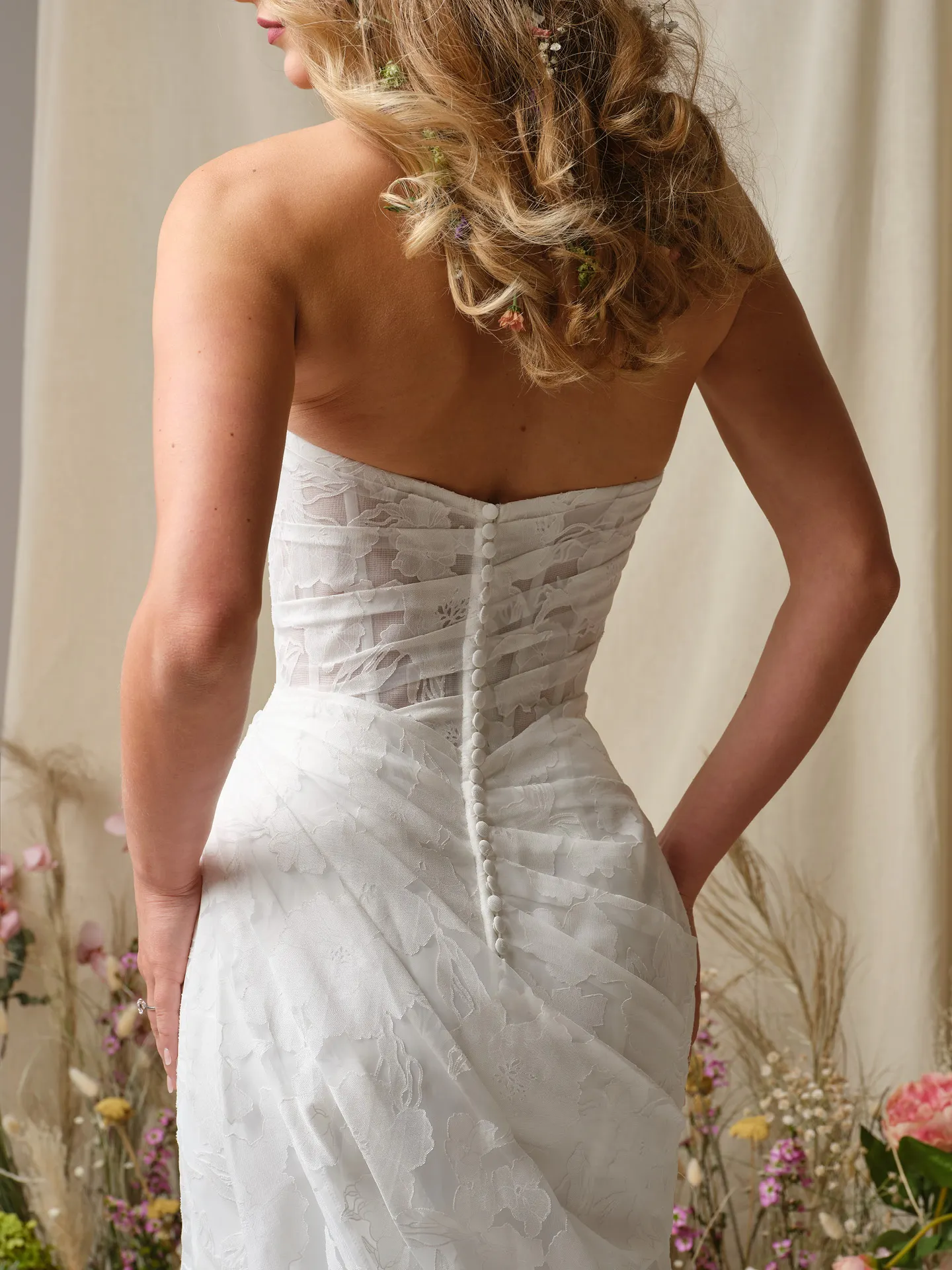 Rebecca Ingram Kendall back view, floral organza sheath dress, button detail, floral backdrop