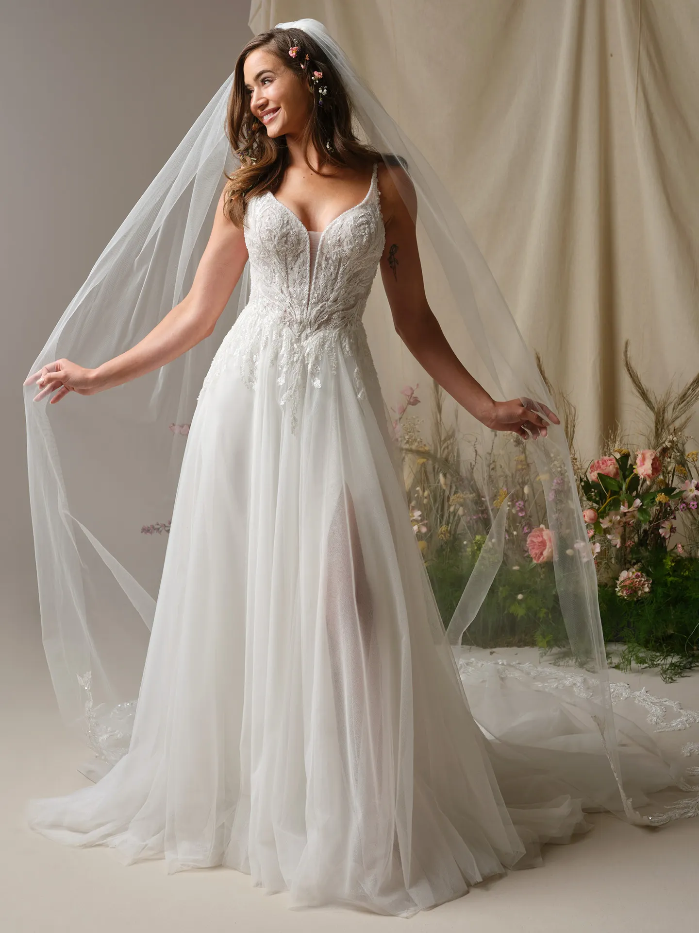 Rebecca Ingram Valarie front view, lace A-Line wedding dress with plunging V-neck and side slit