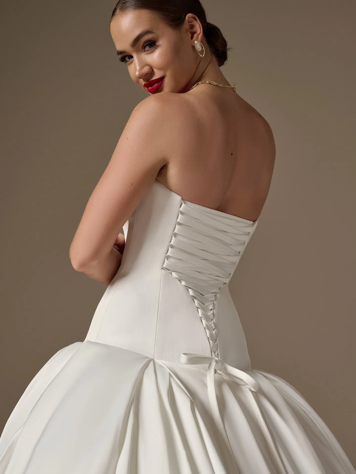 Maggie Sottero Adair, back view strapless satin ballgown with lace-up detail.