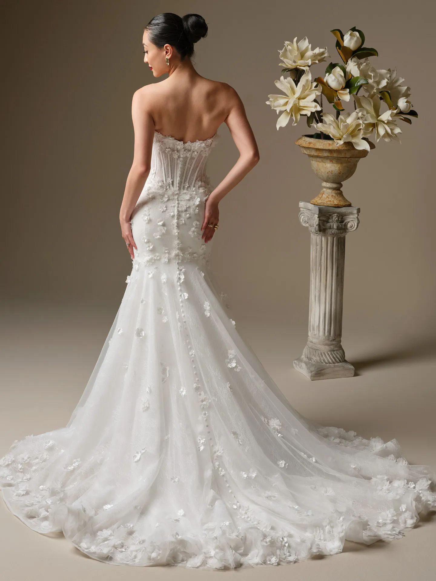 Maggie Sottero Akari, back view with 3-D flowers and fit-and-flare design.